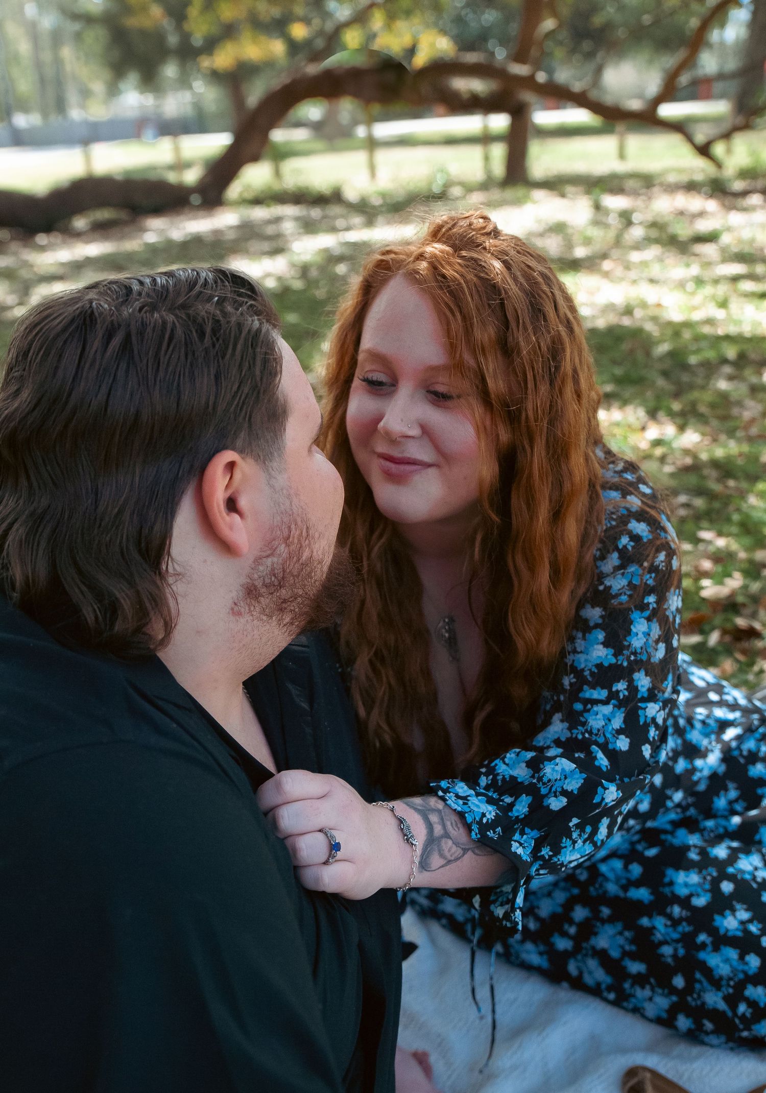 An intimate moment shared between a couple during an outdoor picnic.