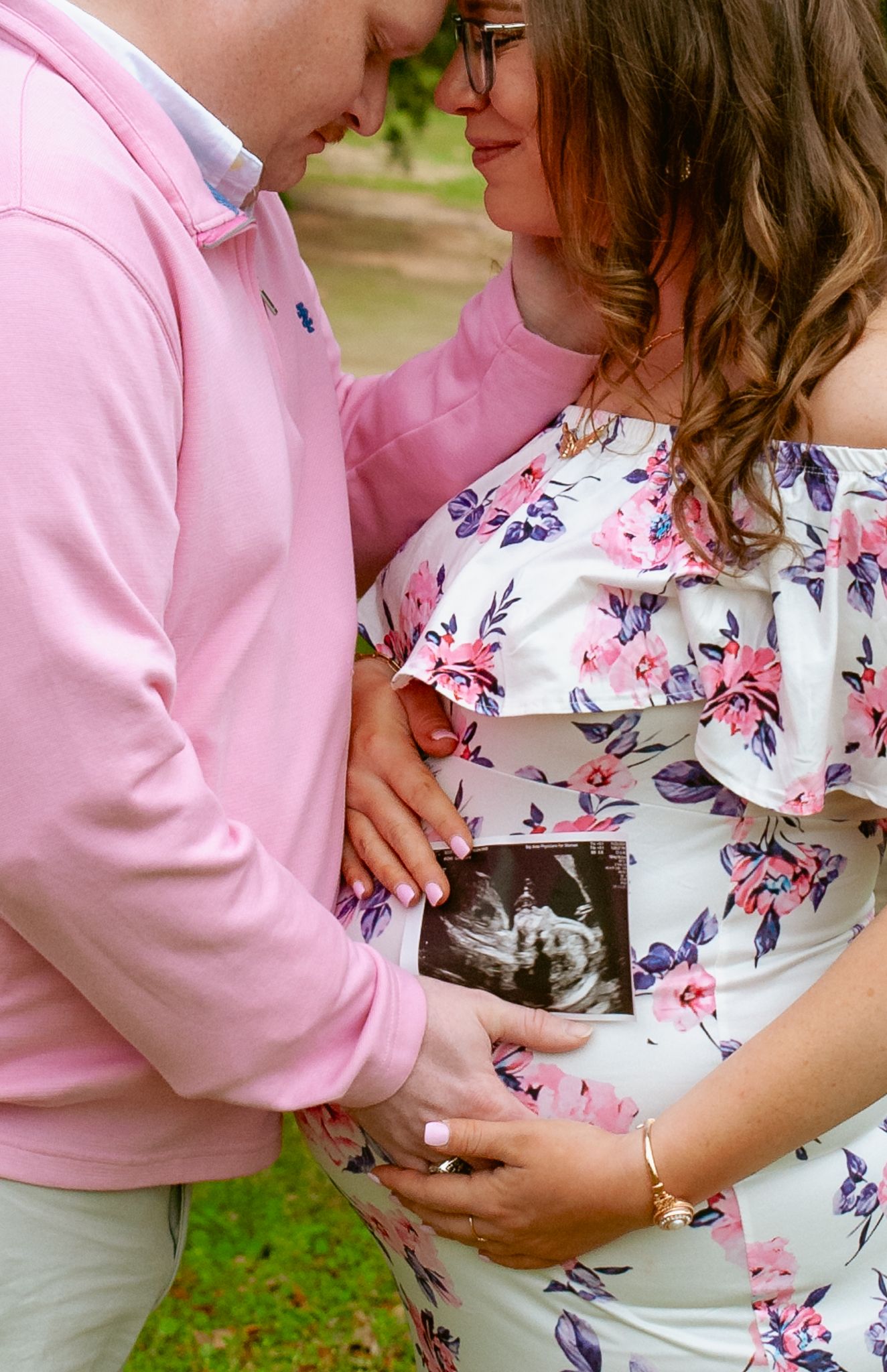 A series of photos showing someone in a pink sweater holding a small black and white kitten against a floral dress.
