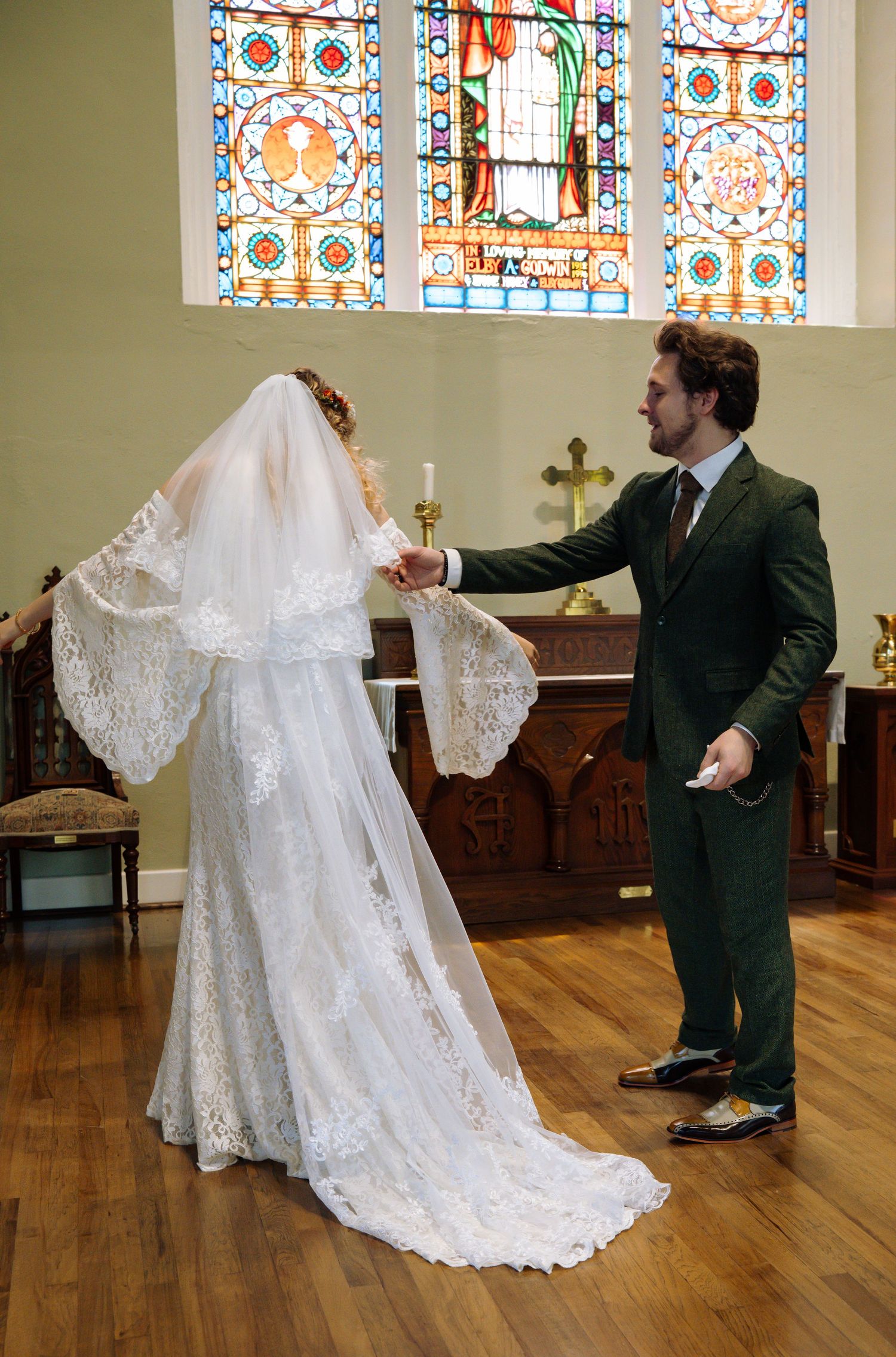 A playful dance sequence in a church with stained glass windows and hardwood floors.