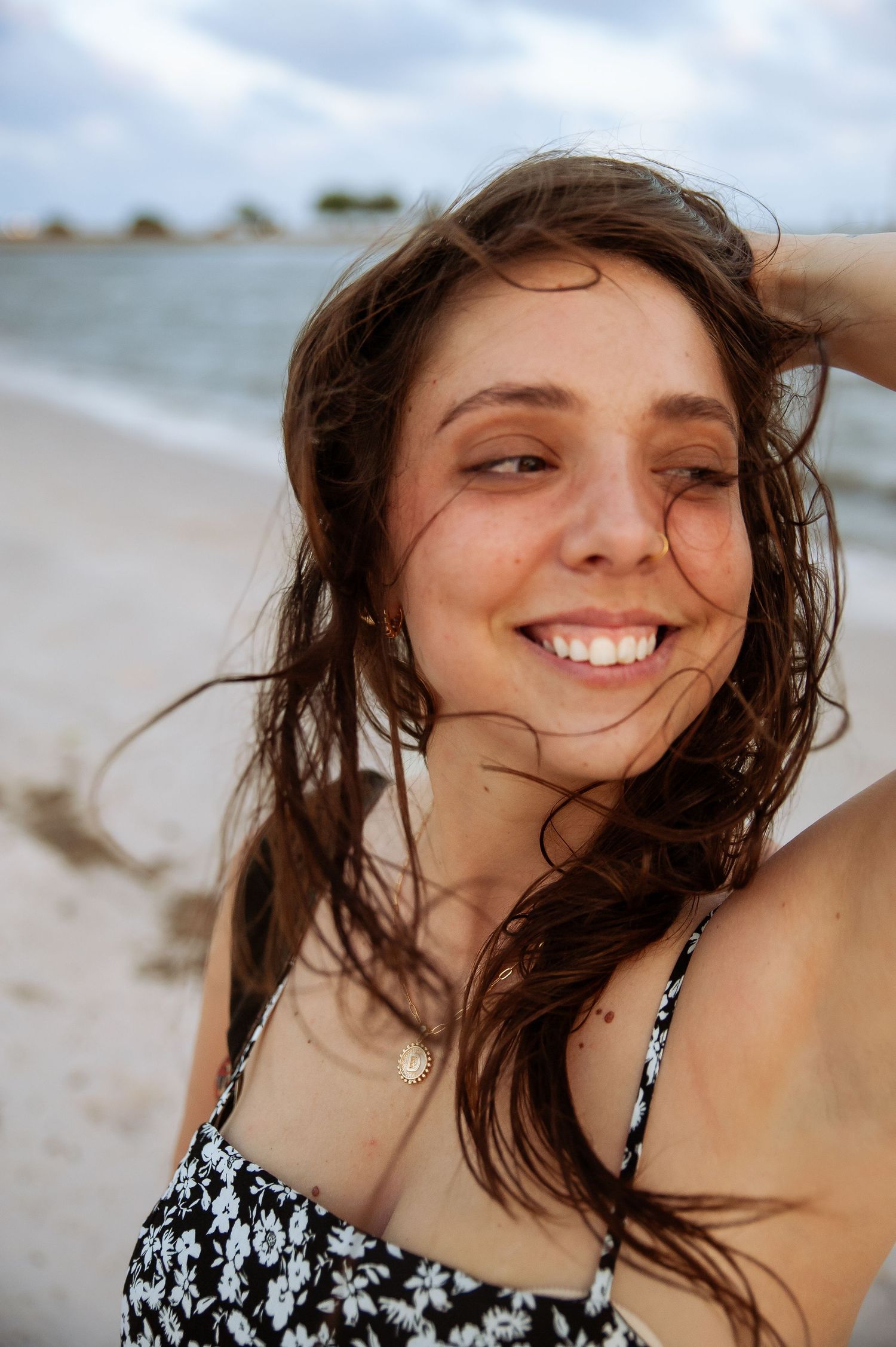 Joyful close-up self portraits on a windy beach with natural lighting.