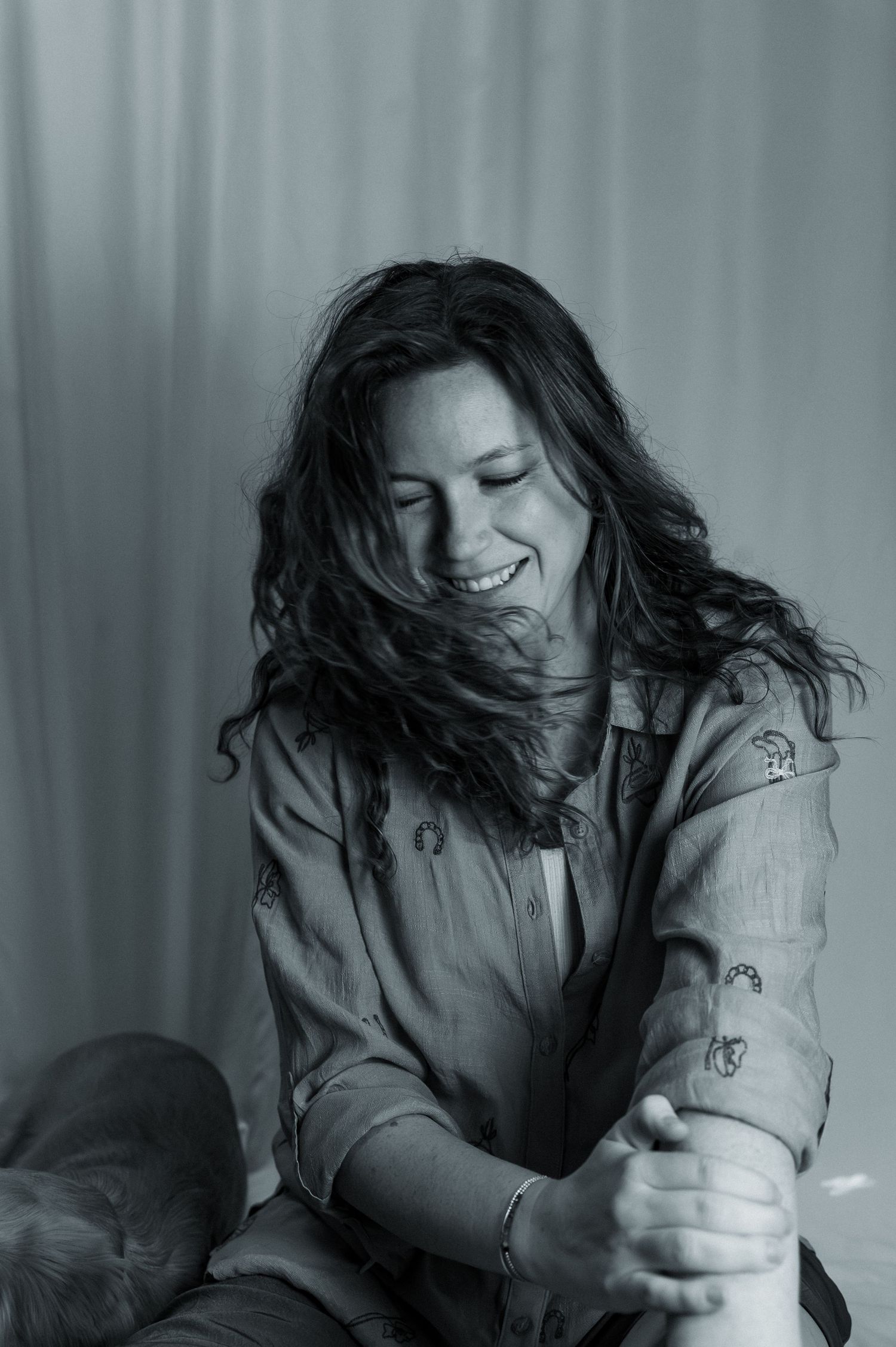 Black and white portrait series showing dynamic movement and flowing hair against a textured background.