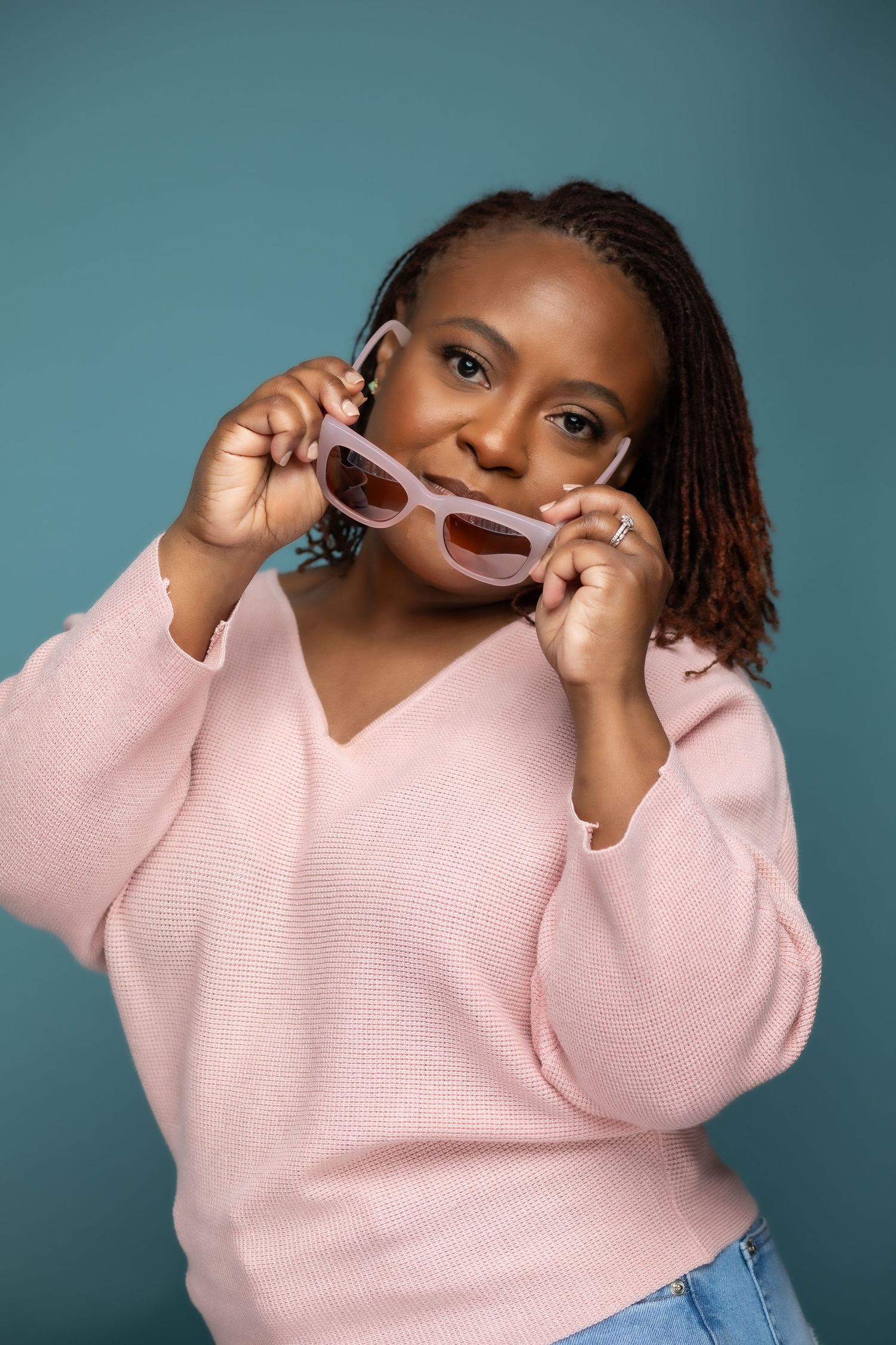 Playful portrait sequence showing pink sweater and sunglasses against teal backdrop.
