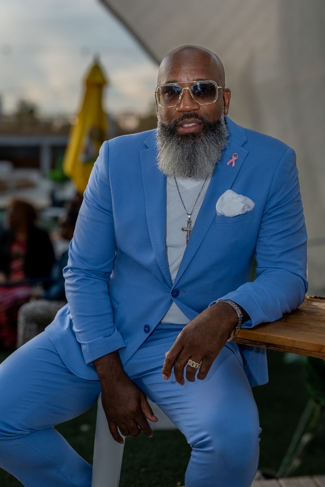 Stylish person in bright blue suit sitting outdoors in casual yet sophisticated poses.