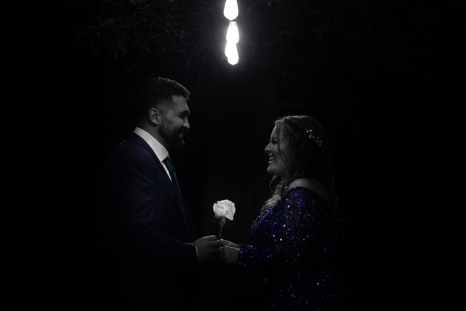 Couple after engagement party under light - black and white photo.
