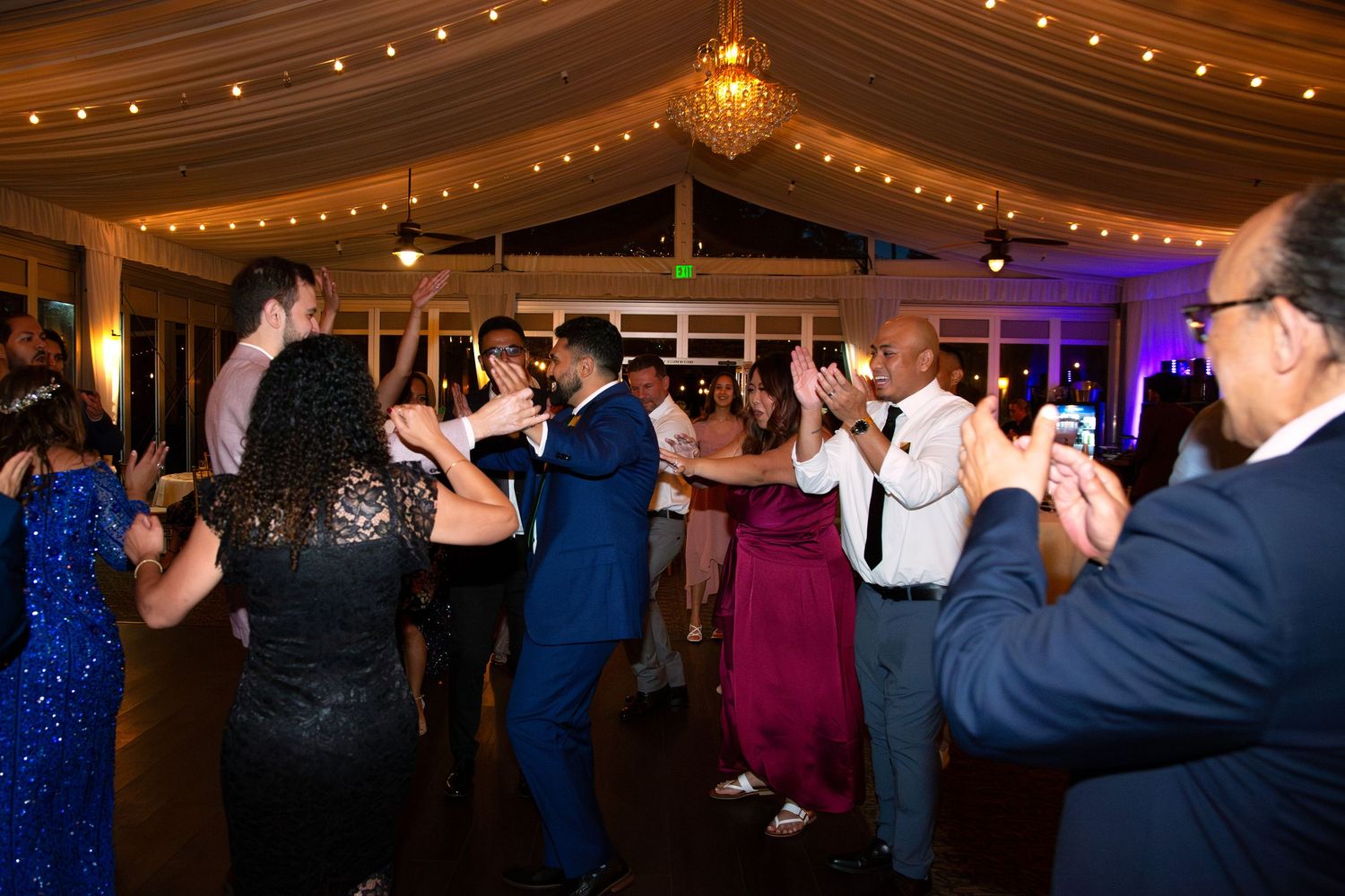 Guests and couple dancing at engagement party.