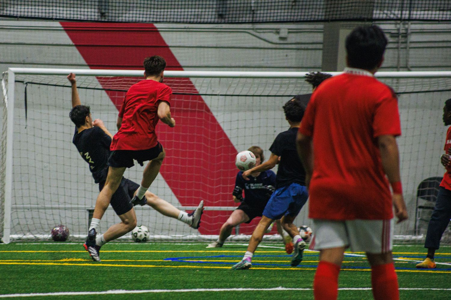 Young players attacking the goal during a Twin Cities indoor soccer game