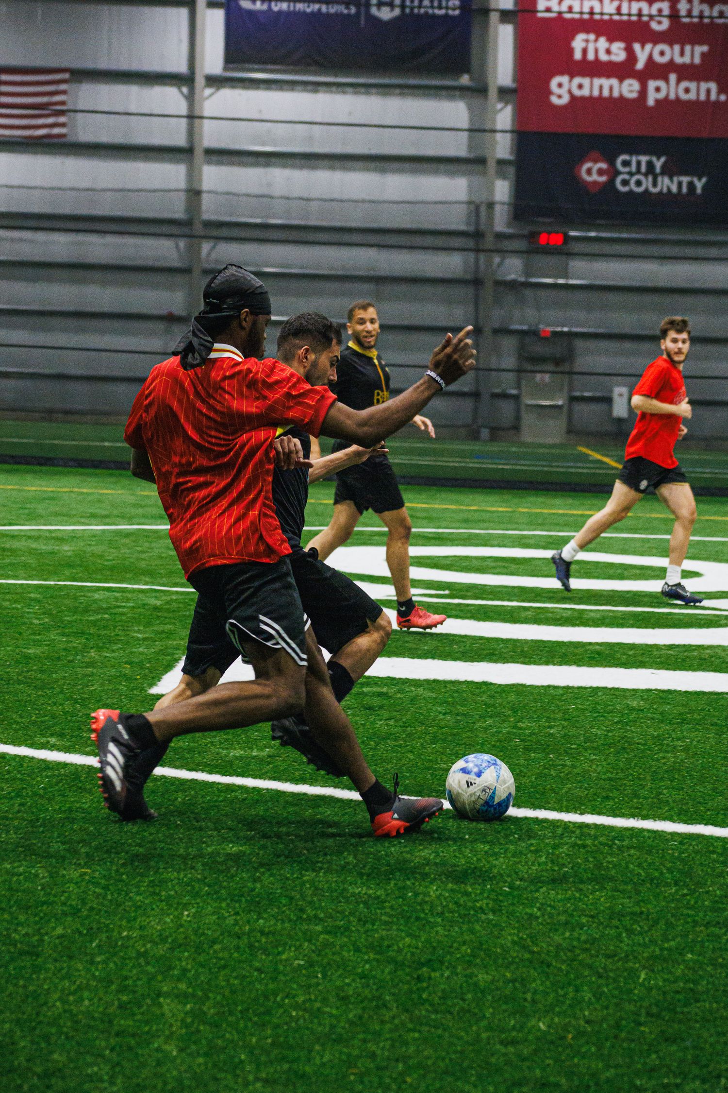 Soccer player advancing the ball upfield in an indoor Minneapolis match