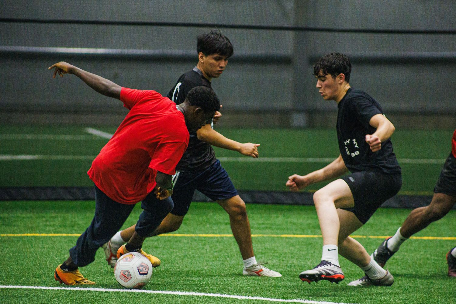 Soccer player controlling the ball during an indoor Minneapolis league game