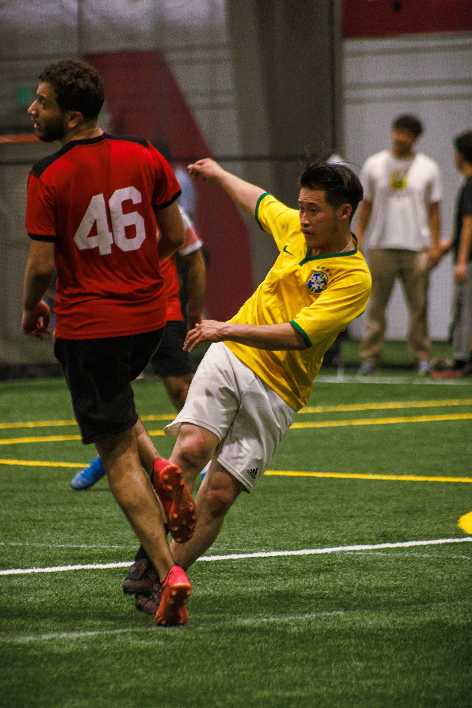 Soccer players challenging for the ball during a Twin Cities league match