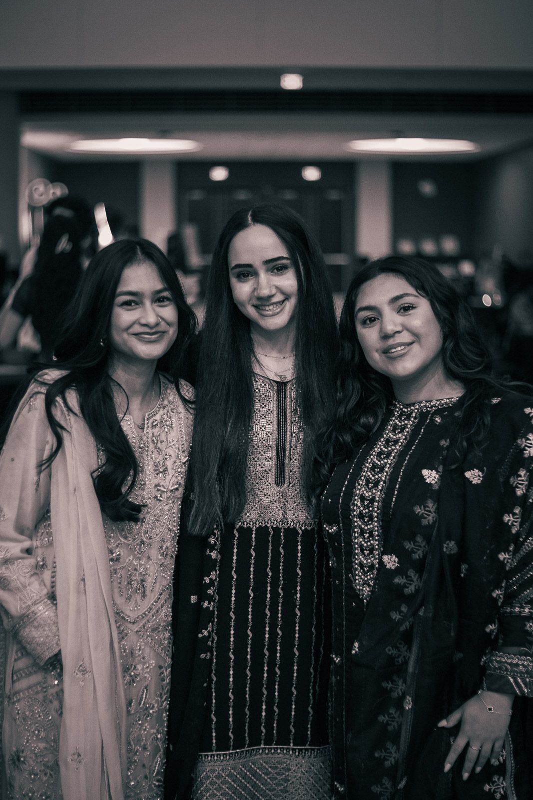 Guests at a multicultural gala at the University of Minnesota, with candid, natural smiles.