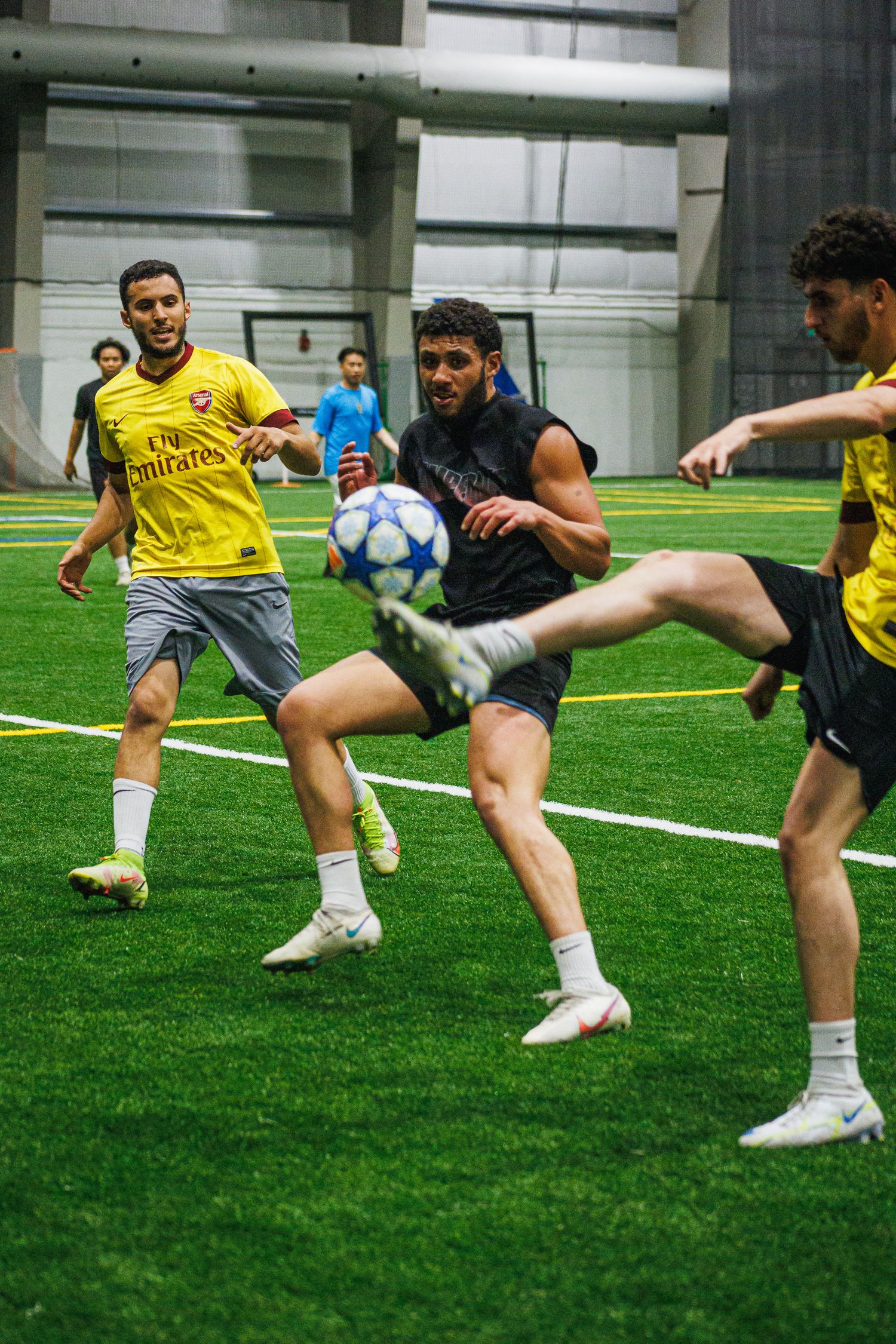 Player volleying the ball during an indoor Twin Cities soccer match