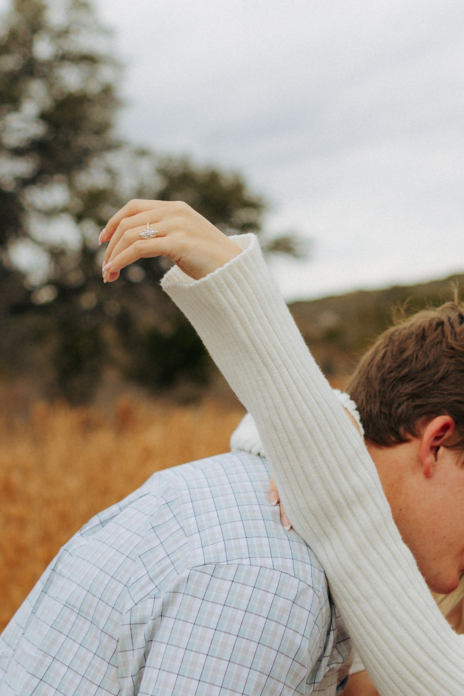 Intimate close-up shot of a couple embracing in an autumn field.