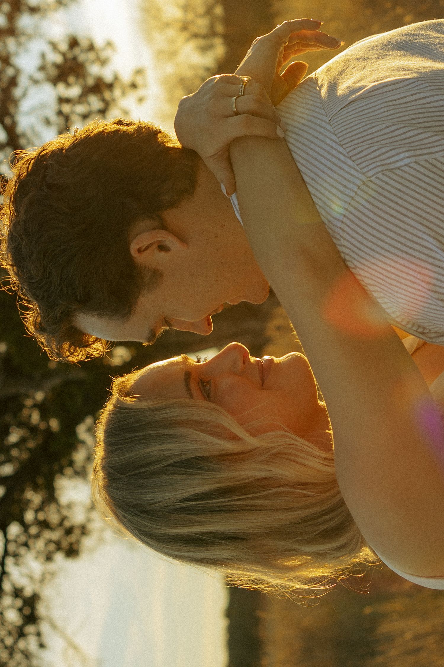 Romantic sunset moment between couple with golden light creating a dreamy atmosphere.
