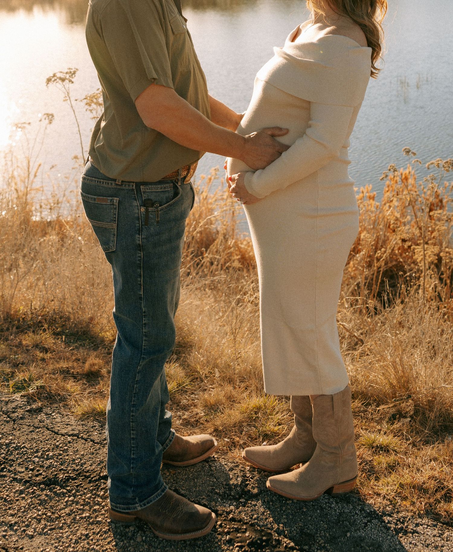 Close-up of couple standing together against a golden sunset backdrop.