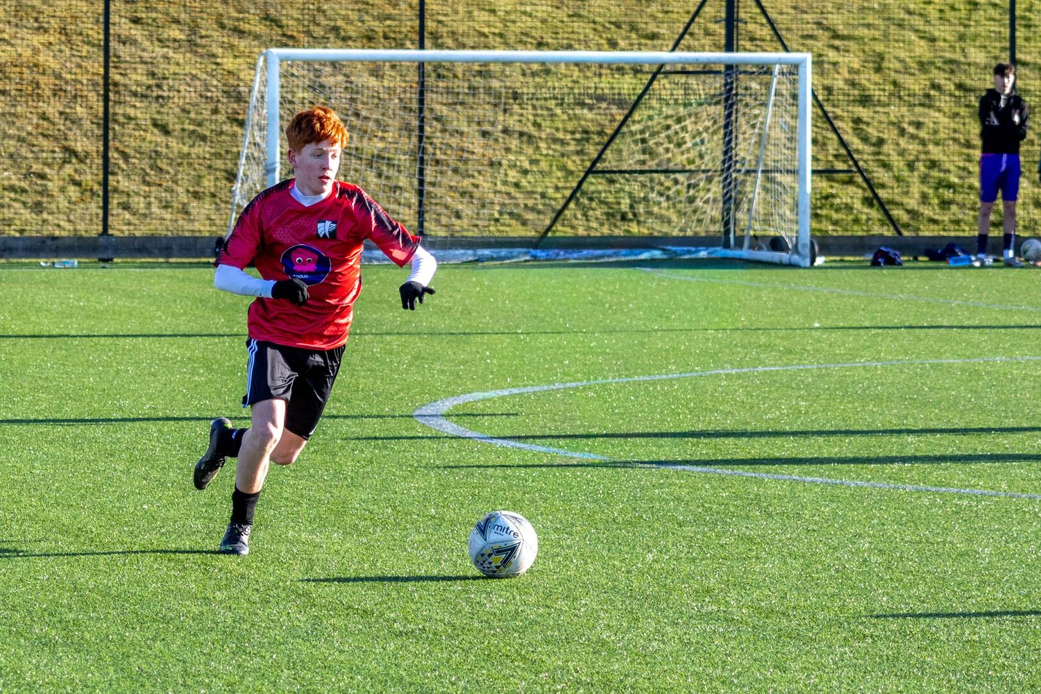 Braes High School football player dribbling the ball