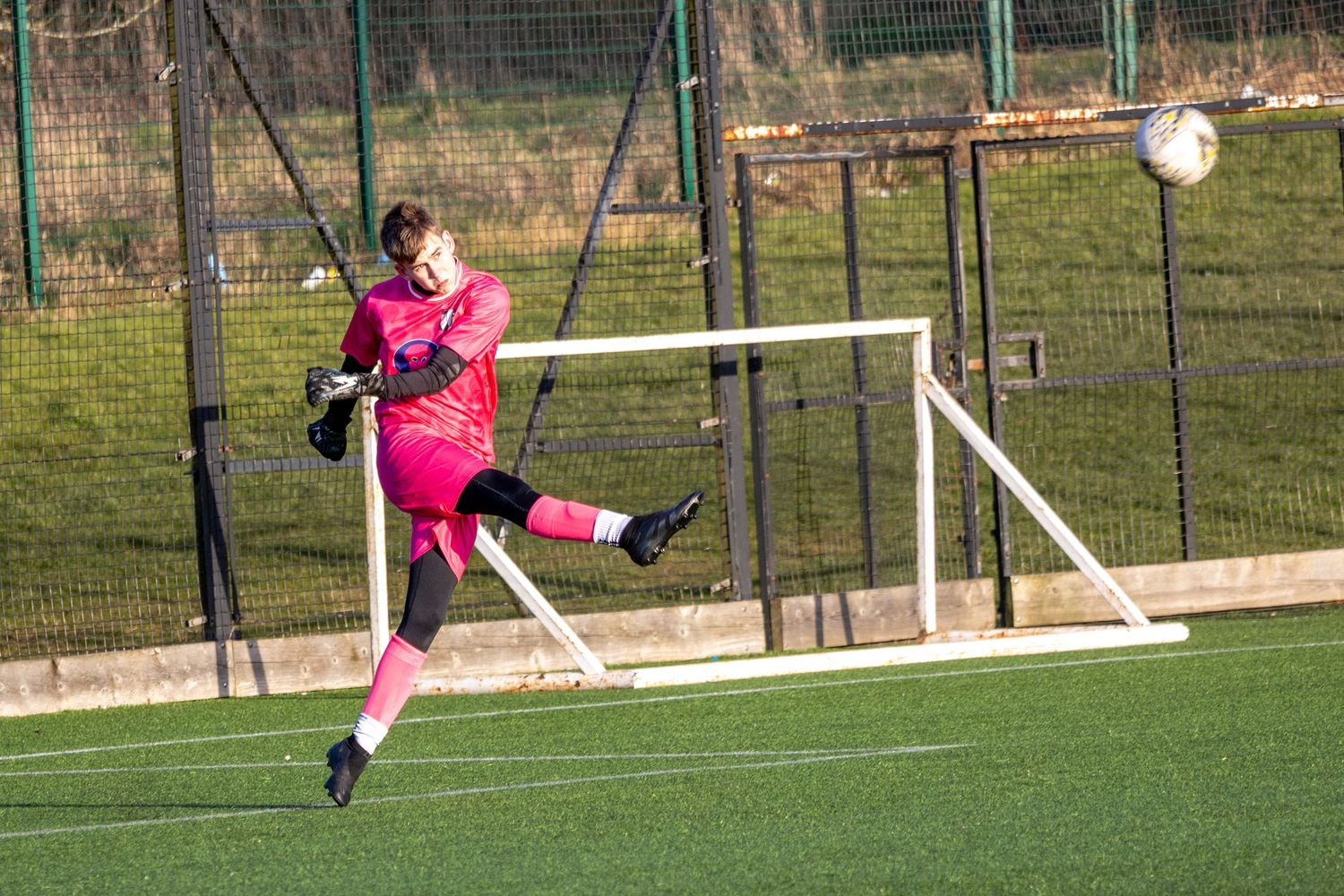 Braes High School football player kicking the ball