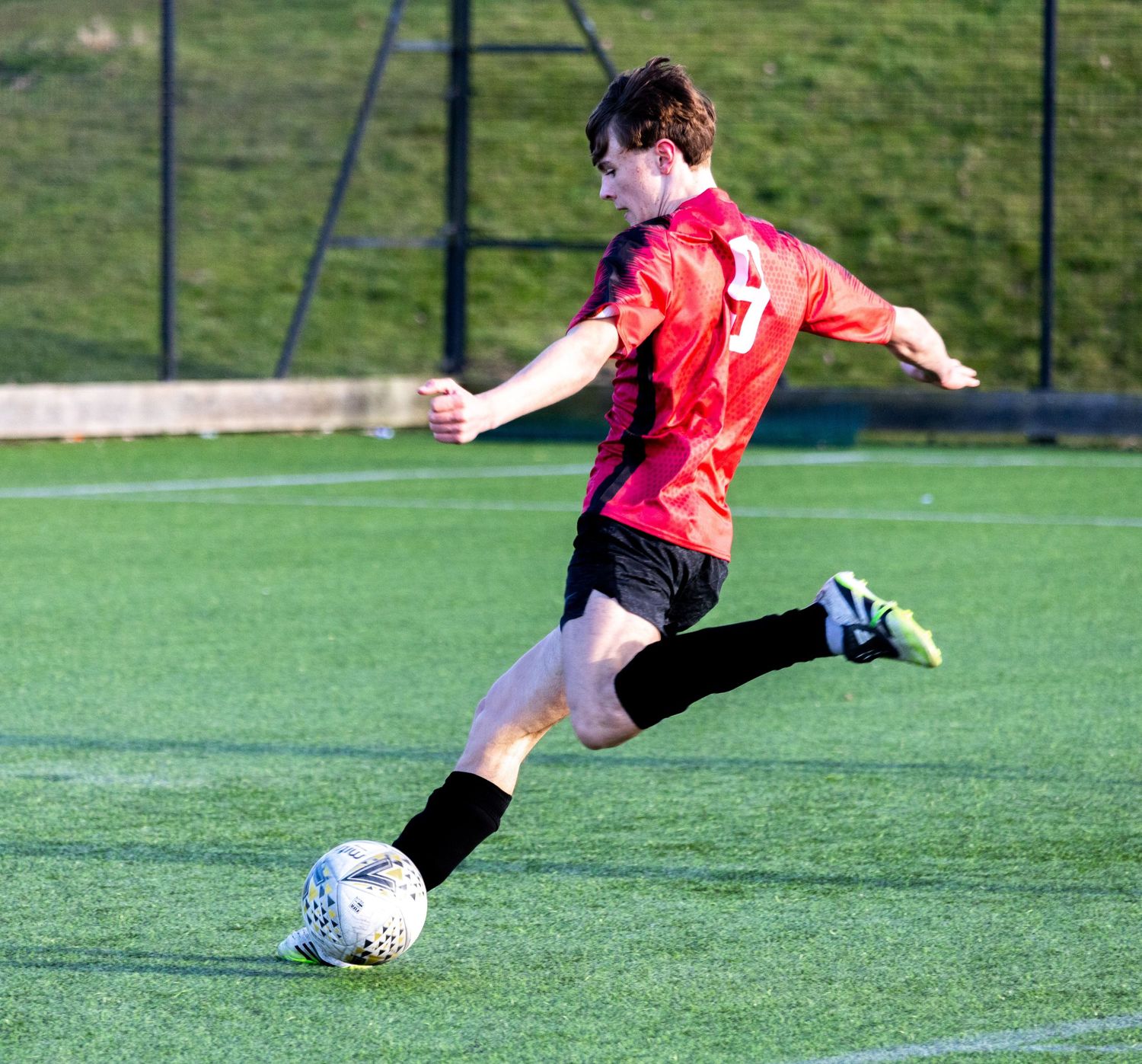 Braes High School football player kicking the ball