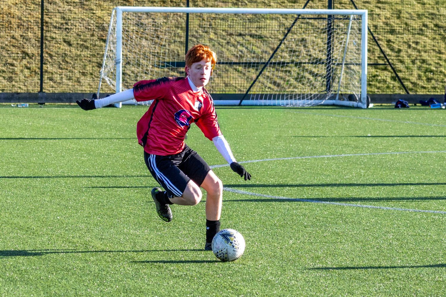 Braes High School football player dribbling the ball