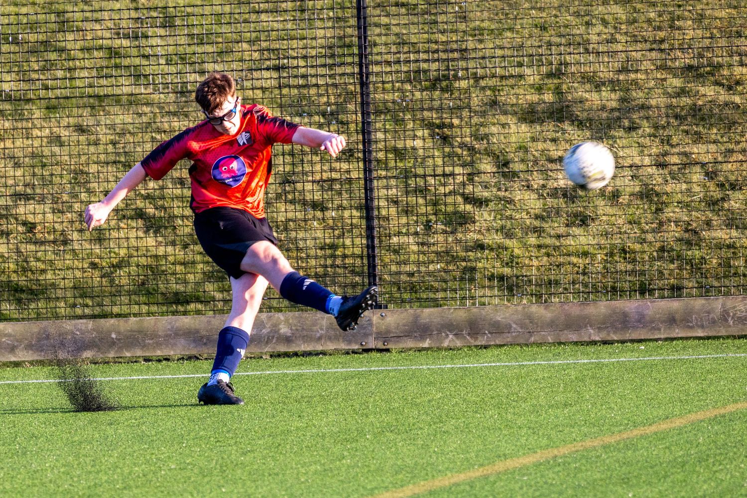Braes High School football player kicking the ball