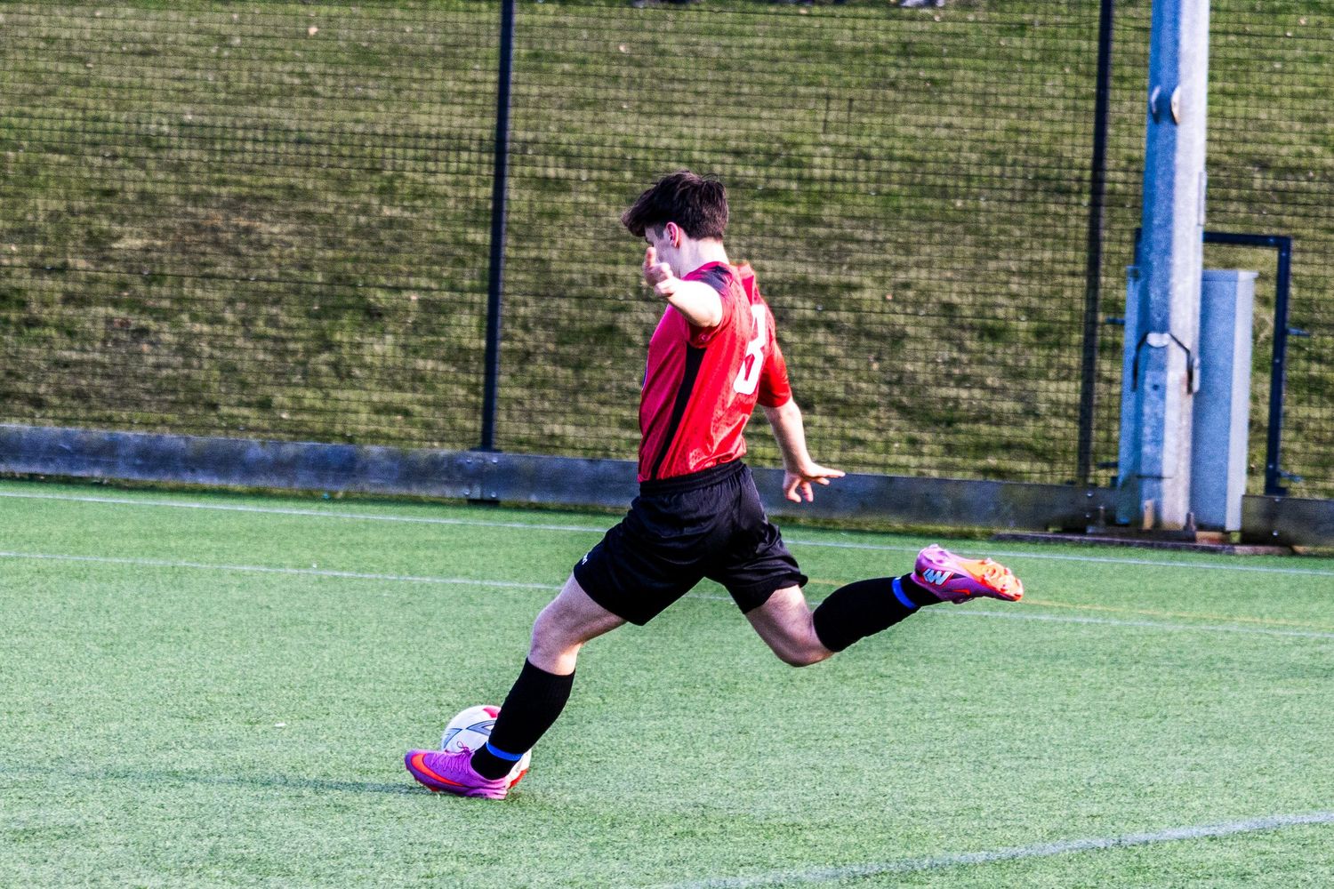 Braes High School football player kicking the ball