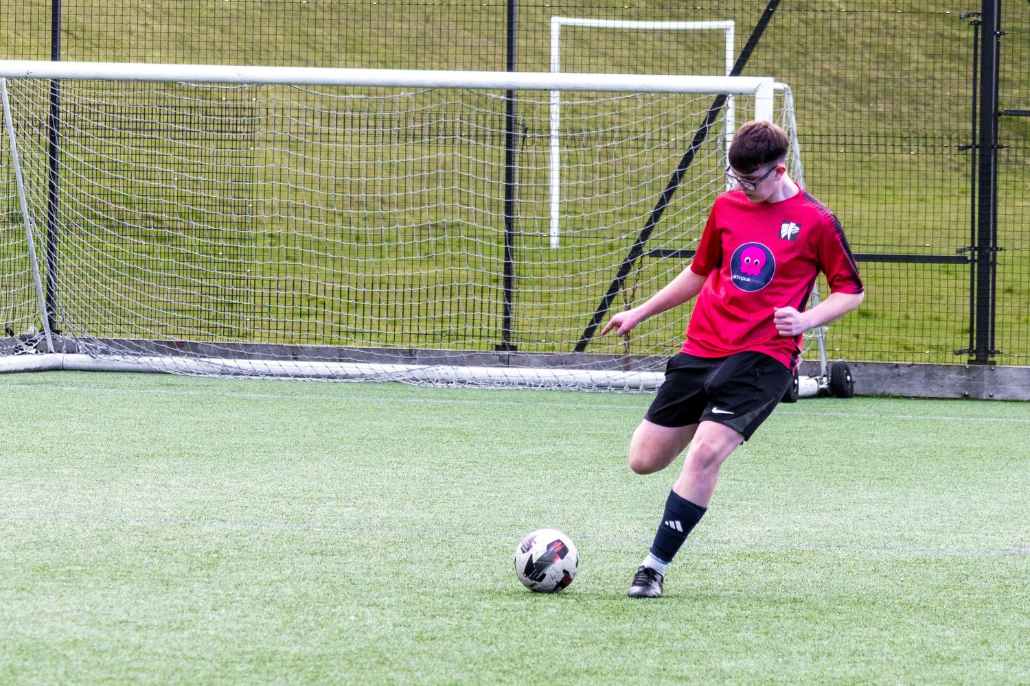 Braes High School football player kicking the ball