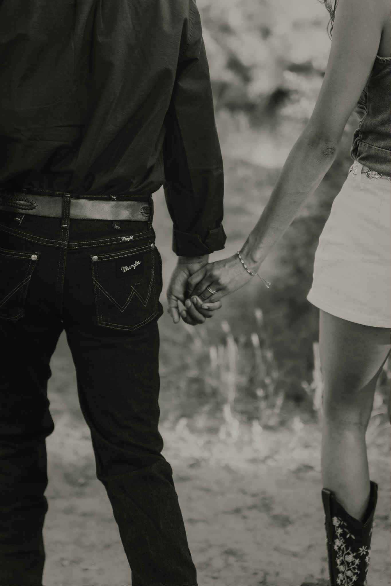 Black and white detail shot focusing on legs and casual clothing.