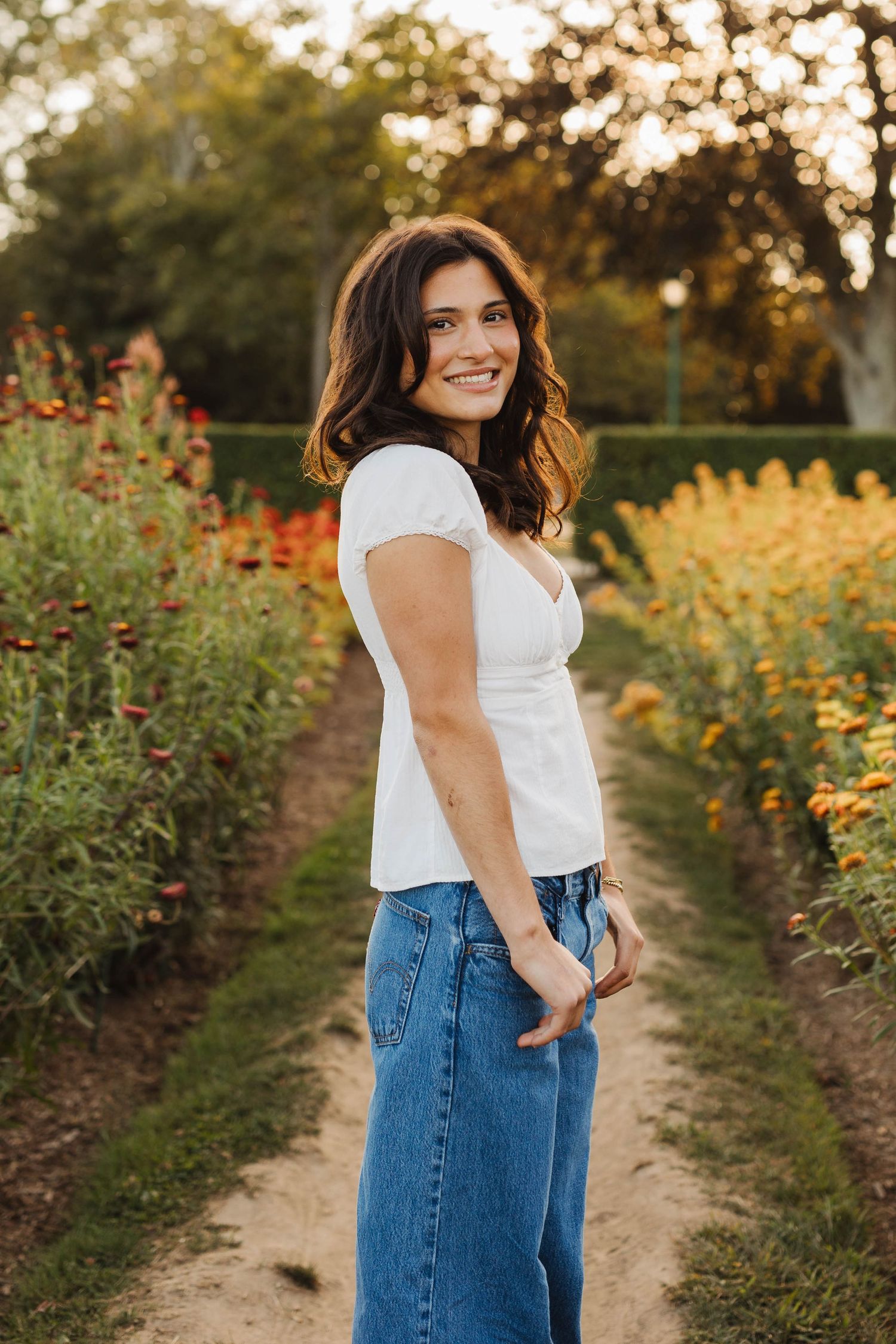 Senior photos at Harkness Memorial State Park featuring elegant garden pathways in Connecticut