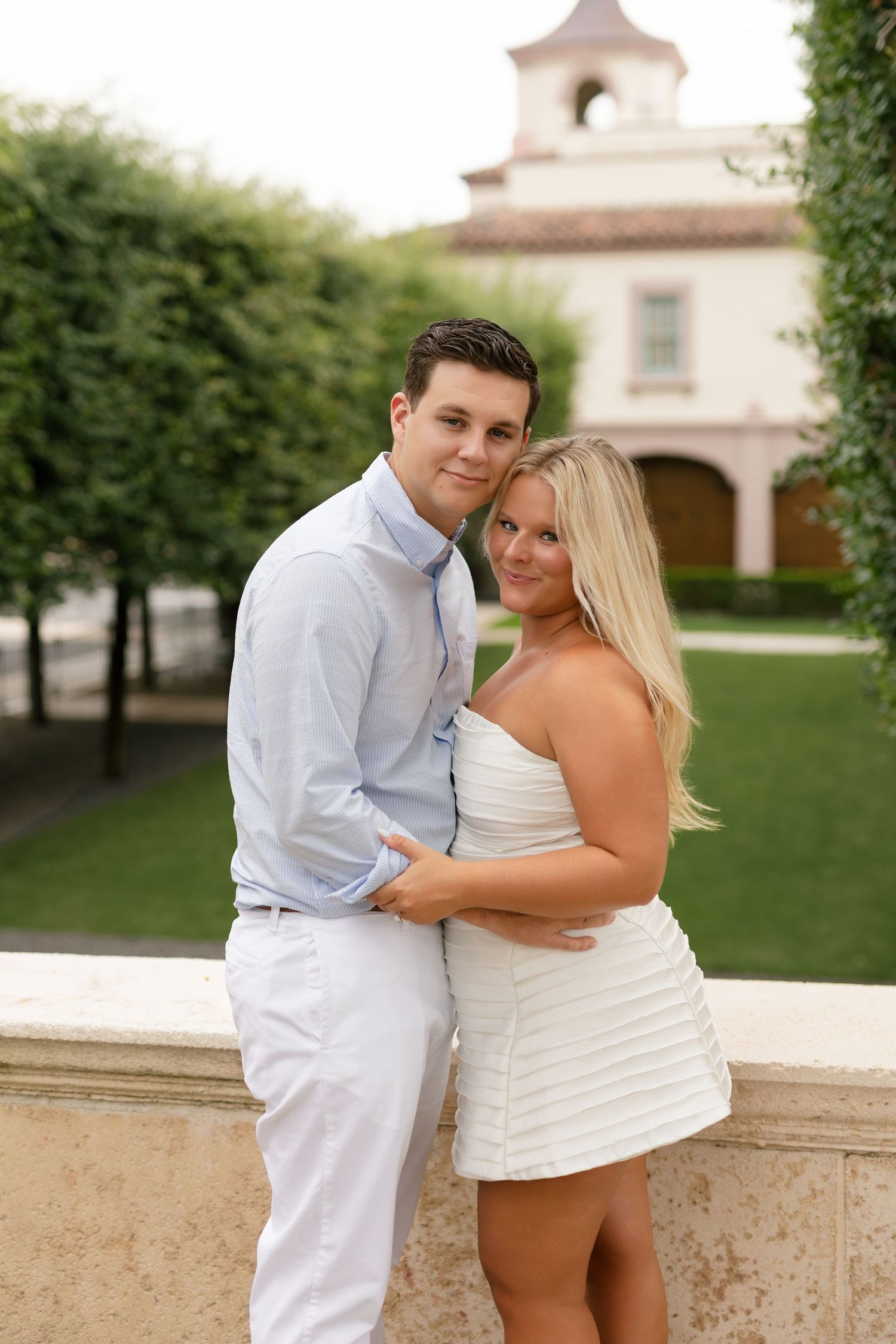 Elliot and Annabel's engagement portraits surrounded by lush tropical greenery on Palm Beach Island, Florida.