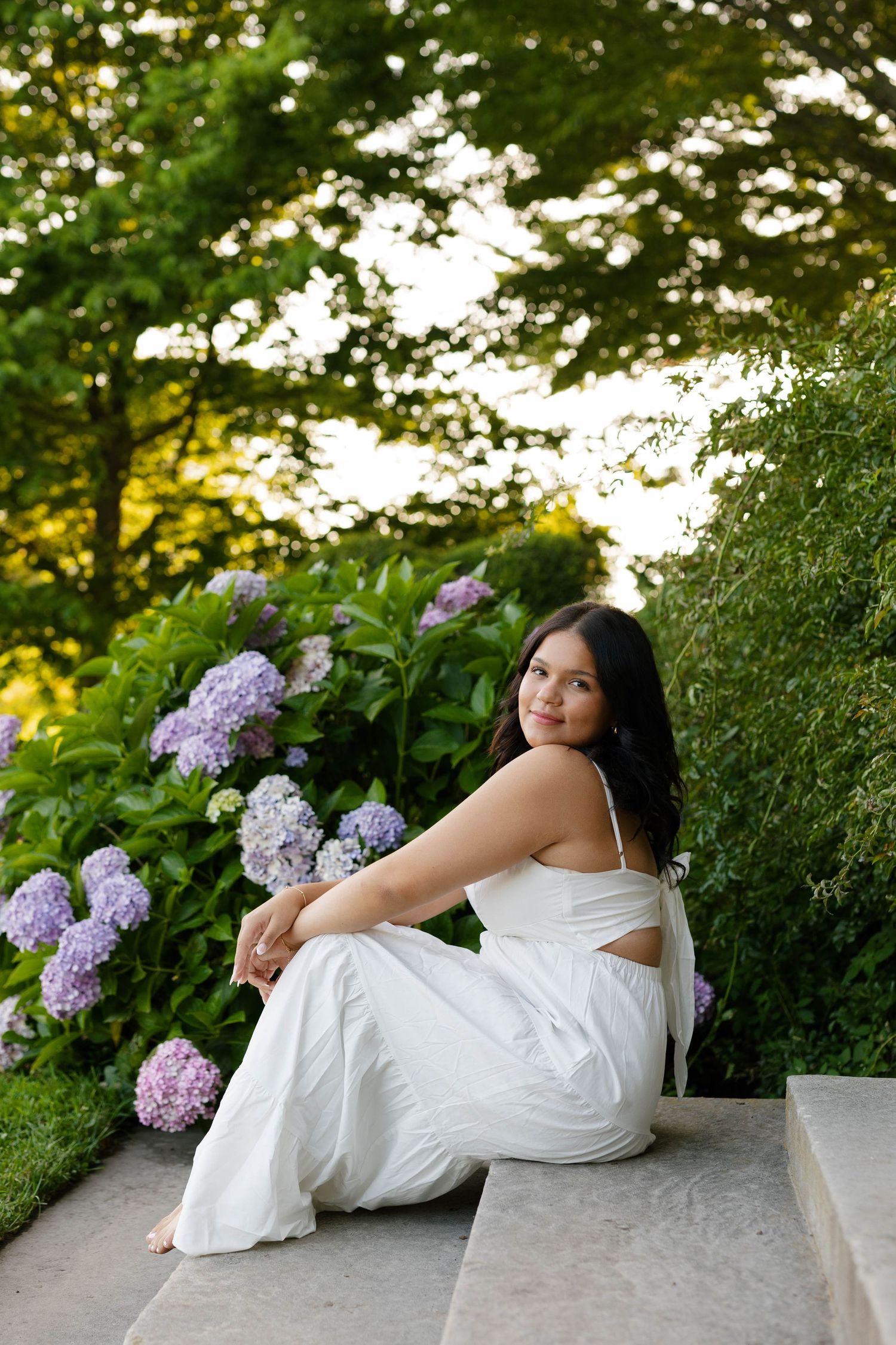 Senior photos at Harkness Memorial State Park featuring elegant garden pathways in Connecticut