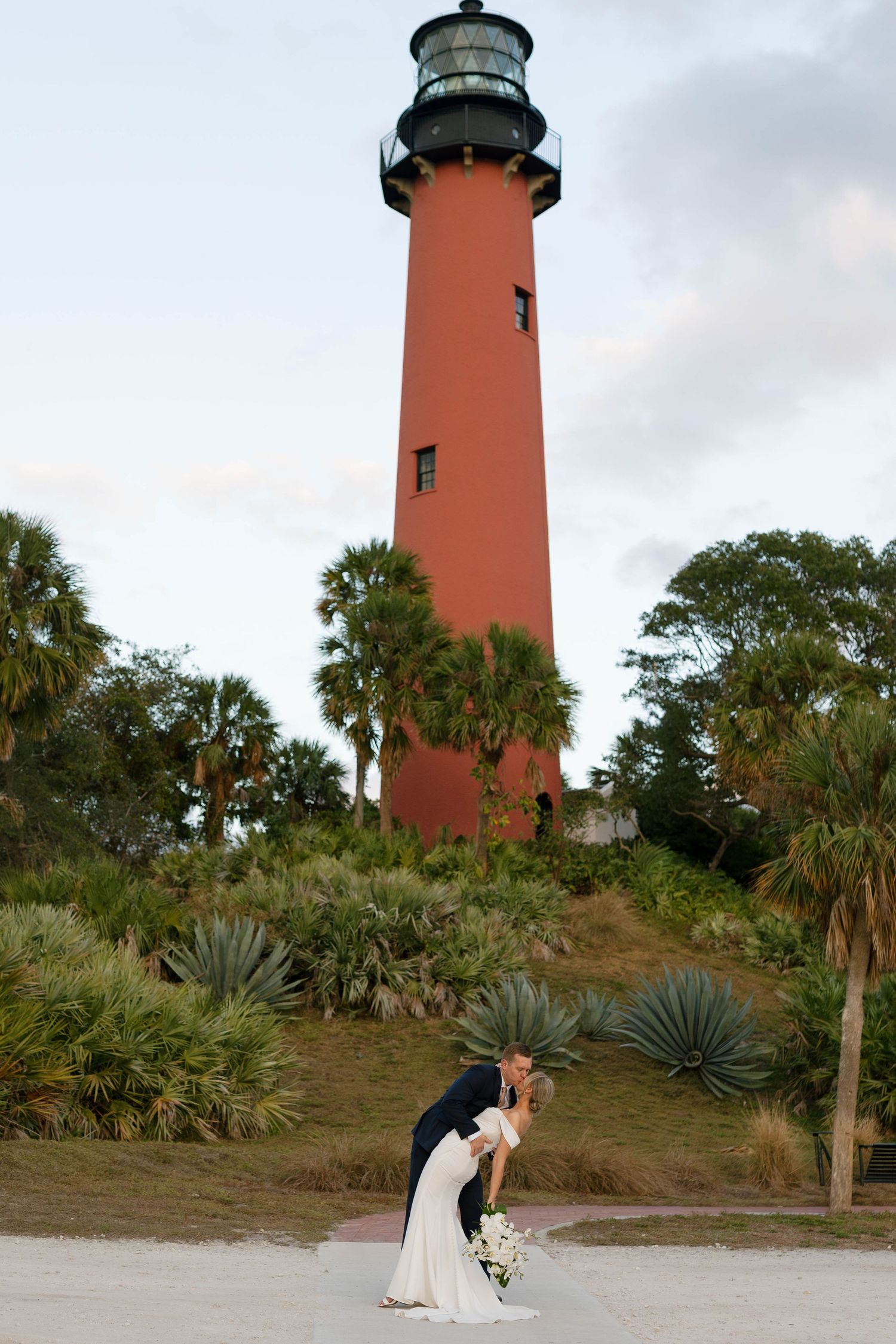 Romantic Jupiter, Florida wedding ceremony surrounded by tropical banyan trees at the historic Jupiter Inlet Lighthouse