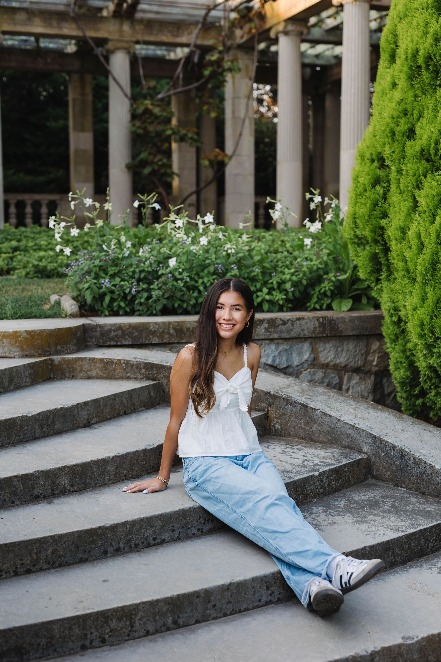 Senior photos at Harkness Memorial State Park featuring elegant garden pathways in Connecticut