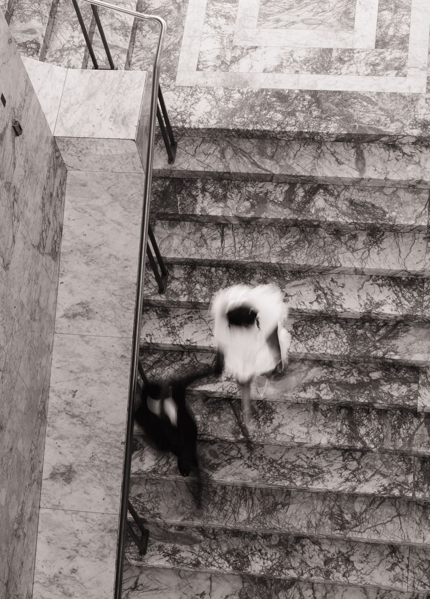 Artistic overhead wedding photo of newlyweds walking the Washington State Capitol stairs
