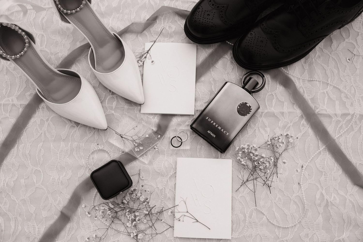Black and white wedding detail photo of shoes, rings and keepsakes from an Olympia wedding
