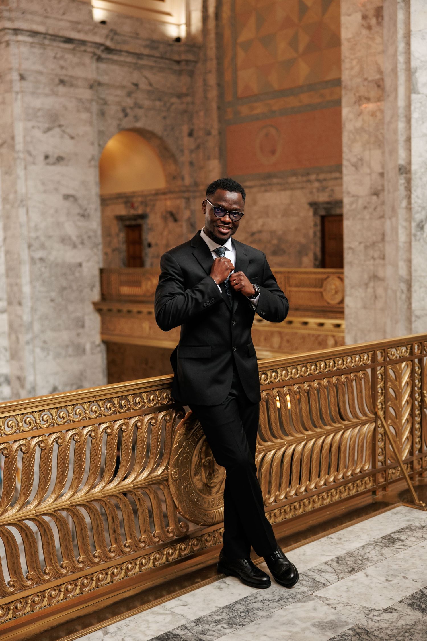 Groom portrait beside the ornate railing inside the Washington State Capitol in Olympia