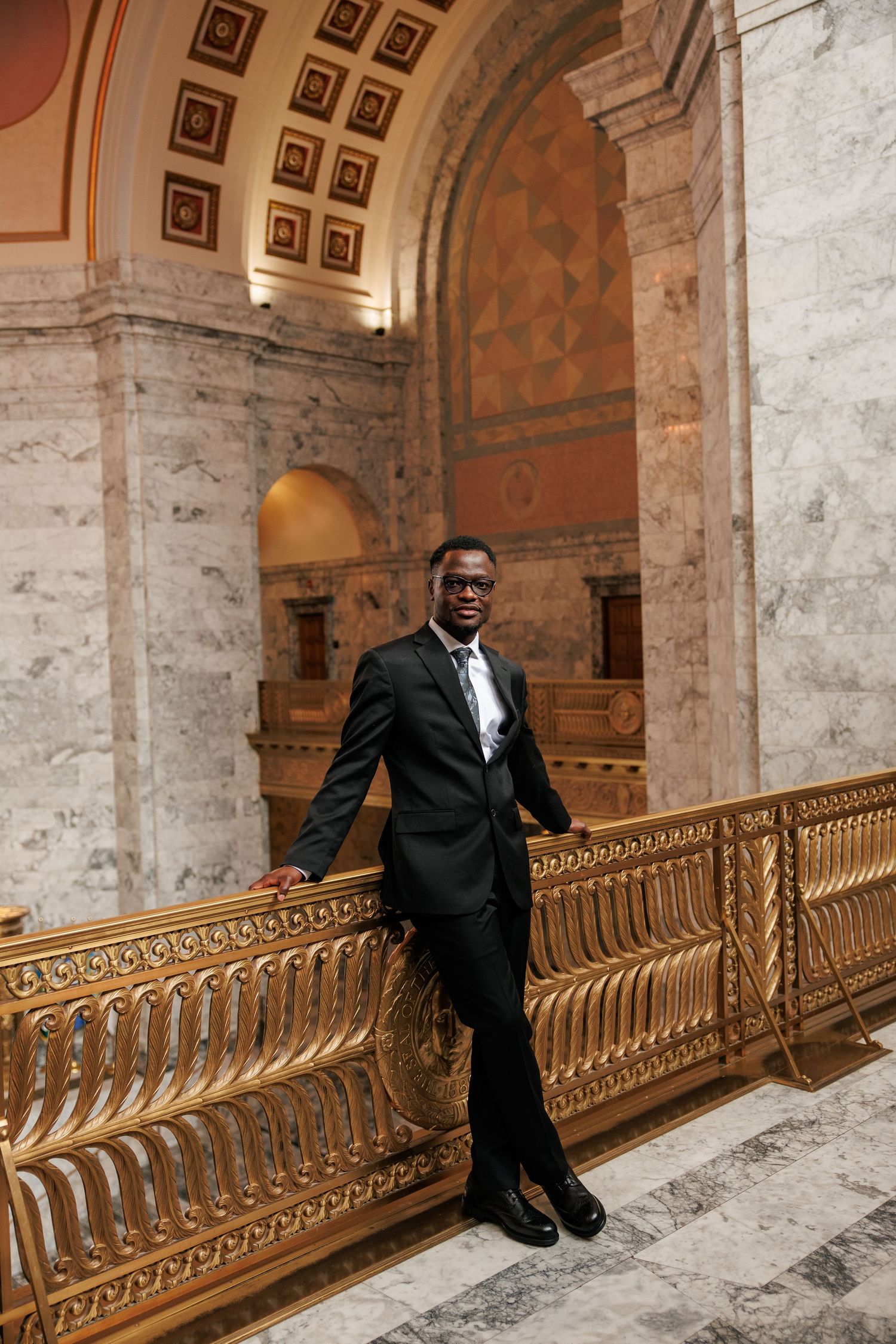 Groom framed by the grand architecture of the Washington State Capitol during his Olympia wedding