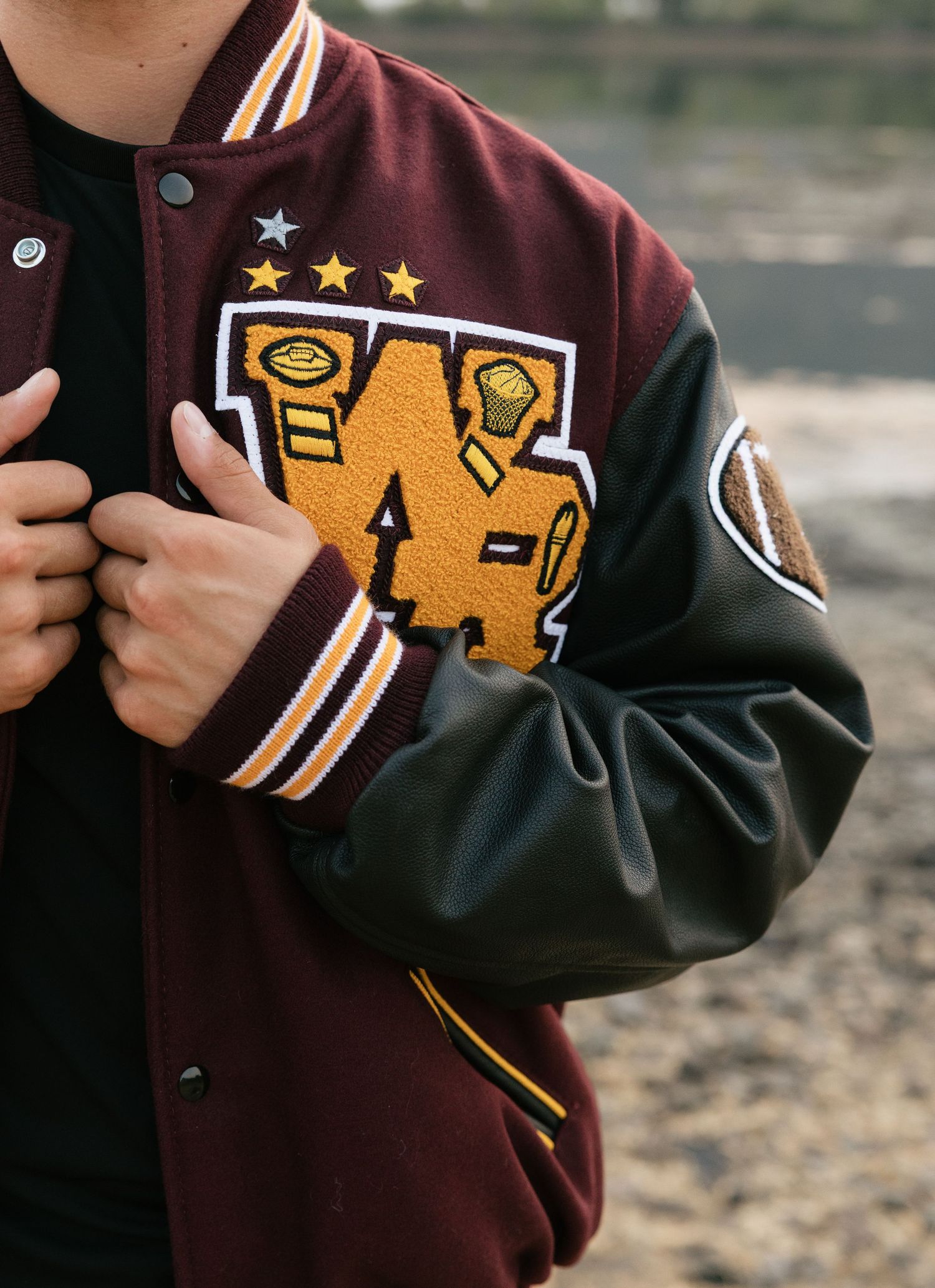 Detail photo of a high school senior’s varsity letterman jacket during his senior photography session.