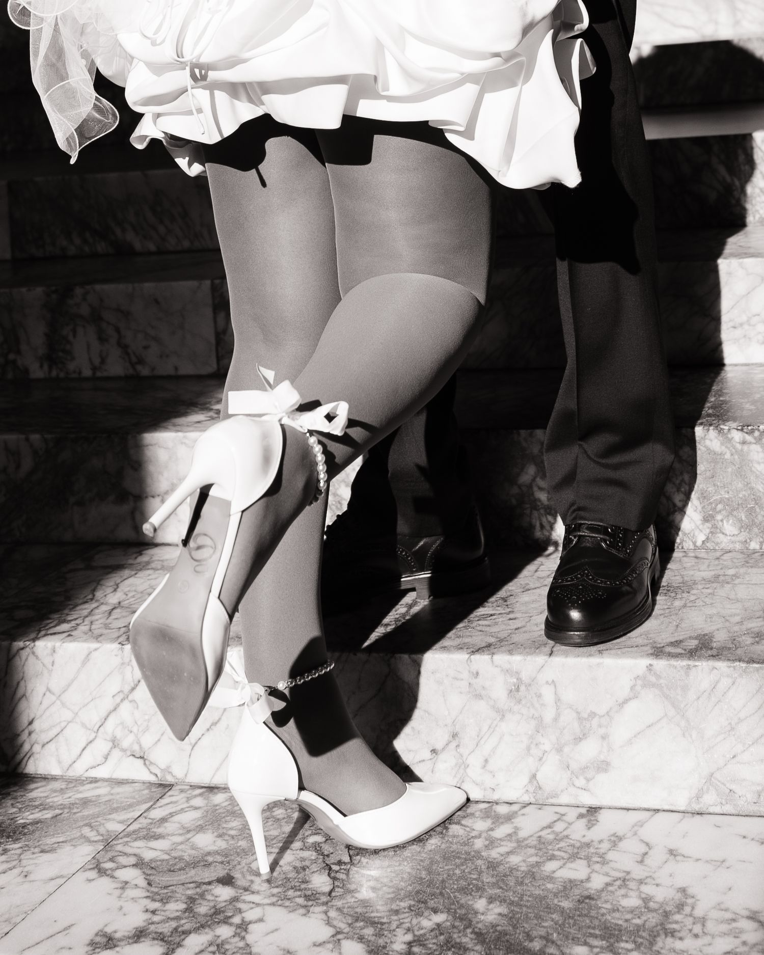 Playful wedding detail of the bride and groom on the Washington State Capitol steps