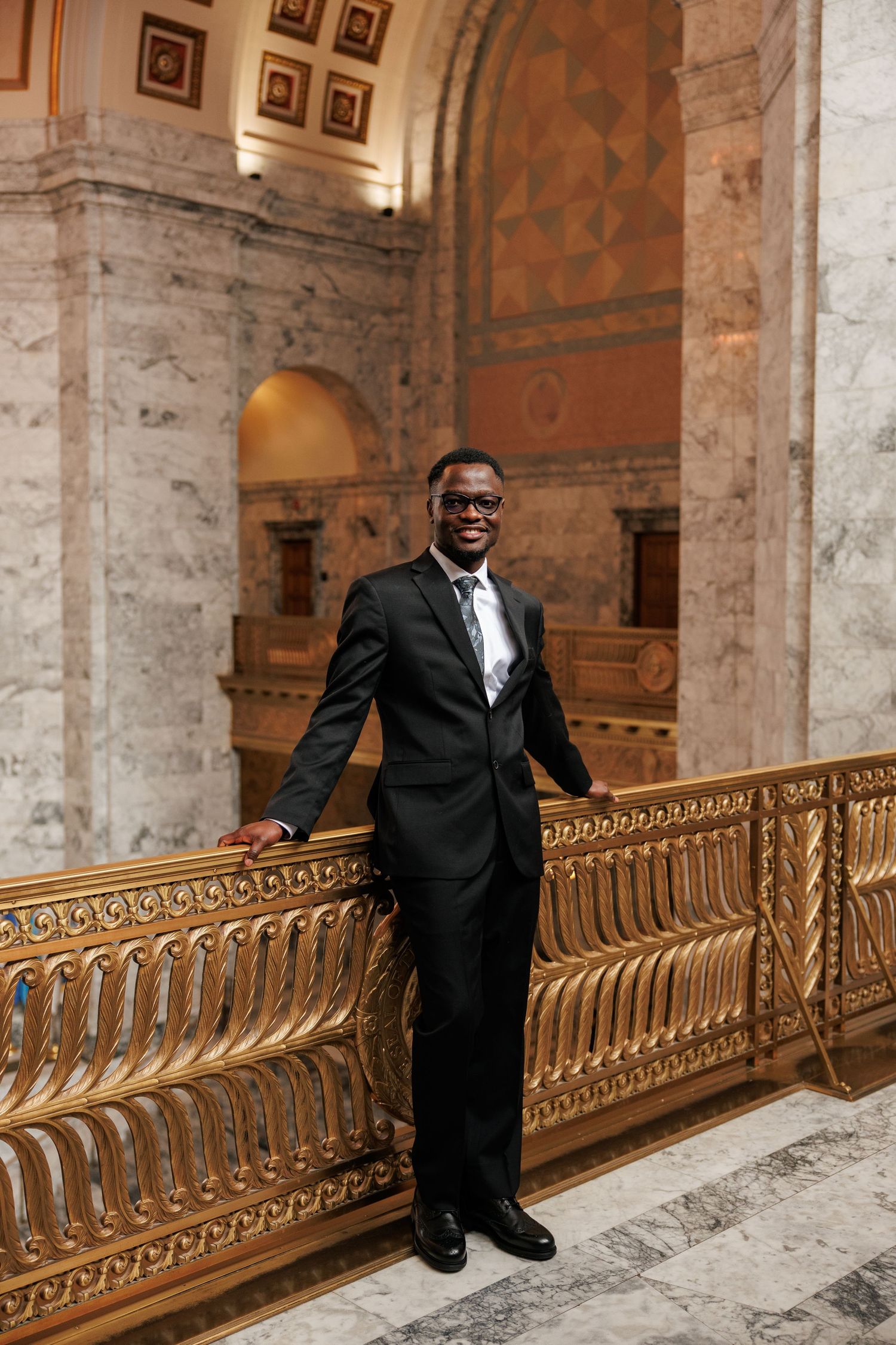 Groom smiling during his wedding portraits inside the Washington State Capitol in Olympia