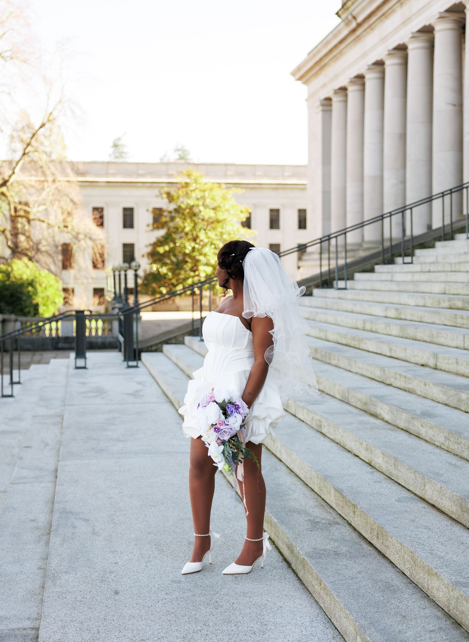 Bride looking toward the Washington State Capitol steps during her Olympia wedding portraits