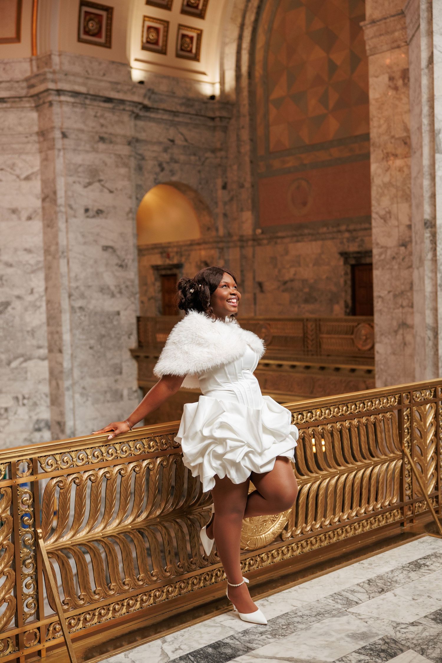 Bride posing beside the ornate railing inside the Washington State Capitol in Olympia