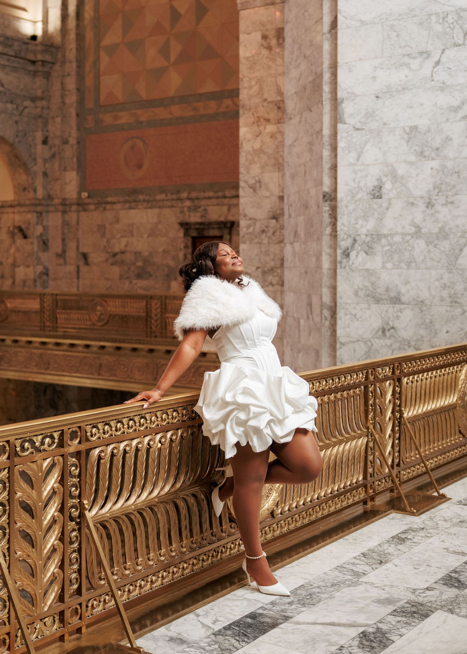 Bride posing beside the ornate railing inside the Washington State Capitol in Olympia
