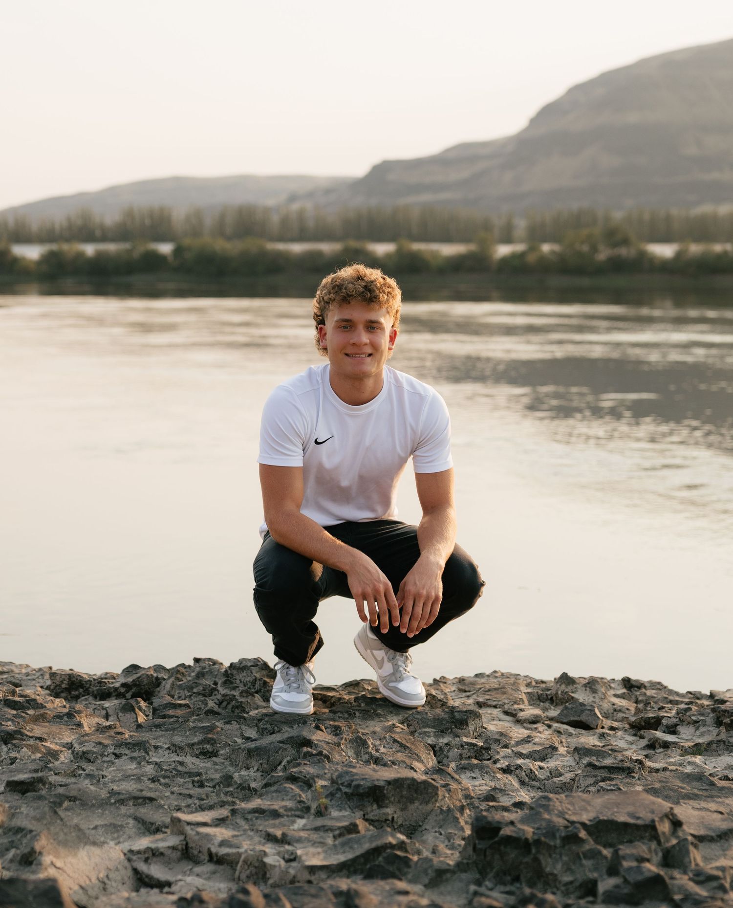 Candid high school senior portrait by the water during a golden hour senior photography session in Washington.