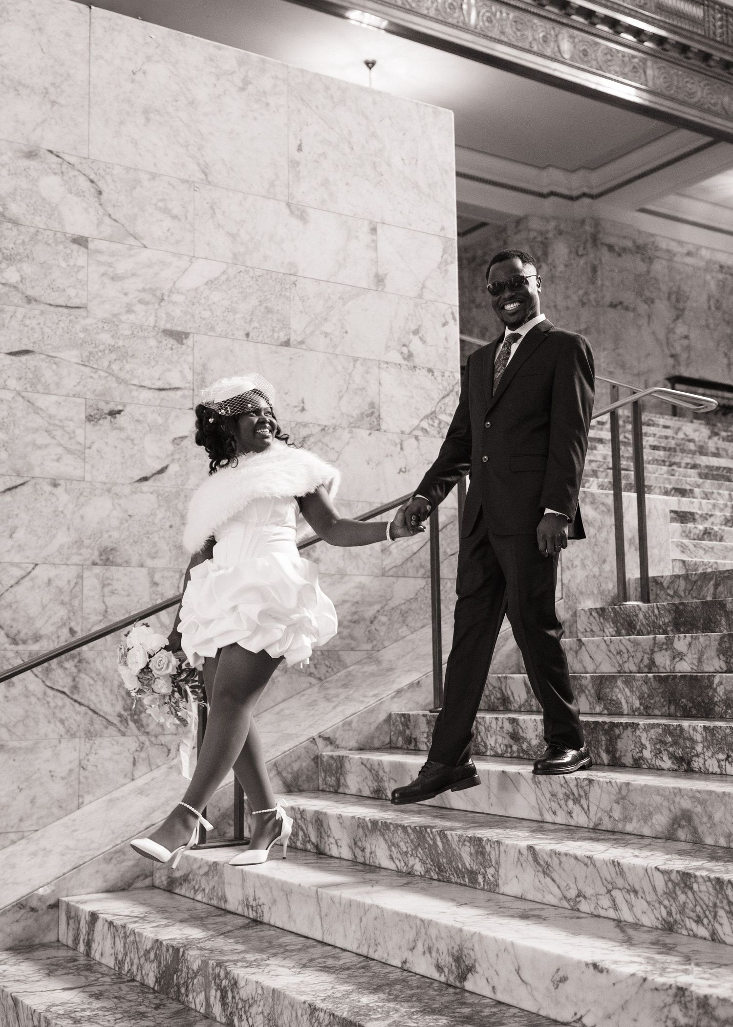 Bride and groom walking hand in hand down the Washington State Capitol stairs