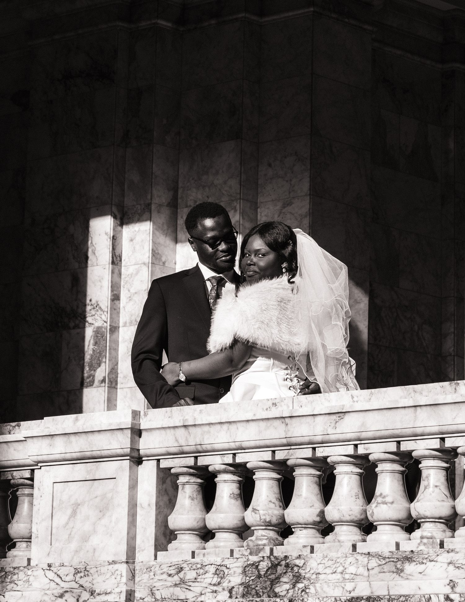 Bride and groom embracing on a balcony inside the Washington State Capitol in Olympia