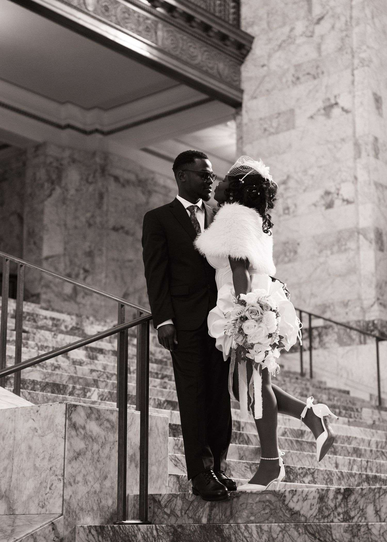 Bride and groom sharing a kiss on the stairs inside the Washington State Capitol in Olympia