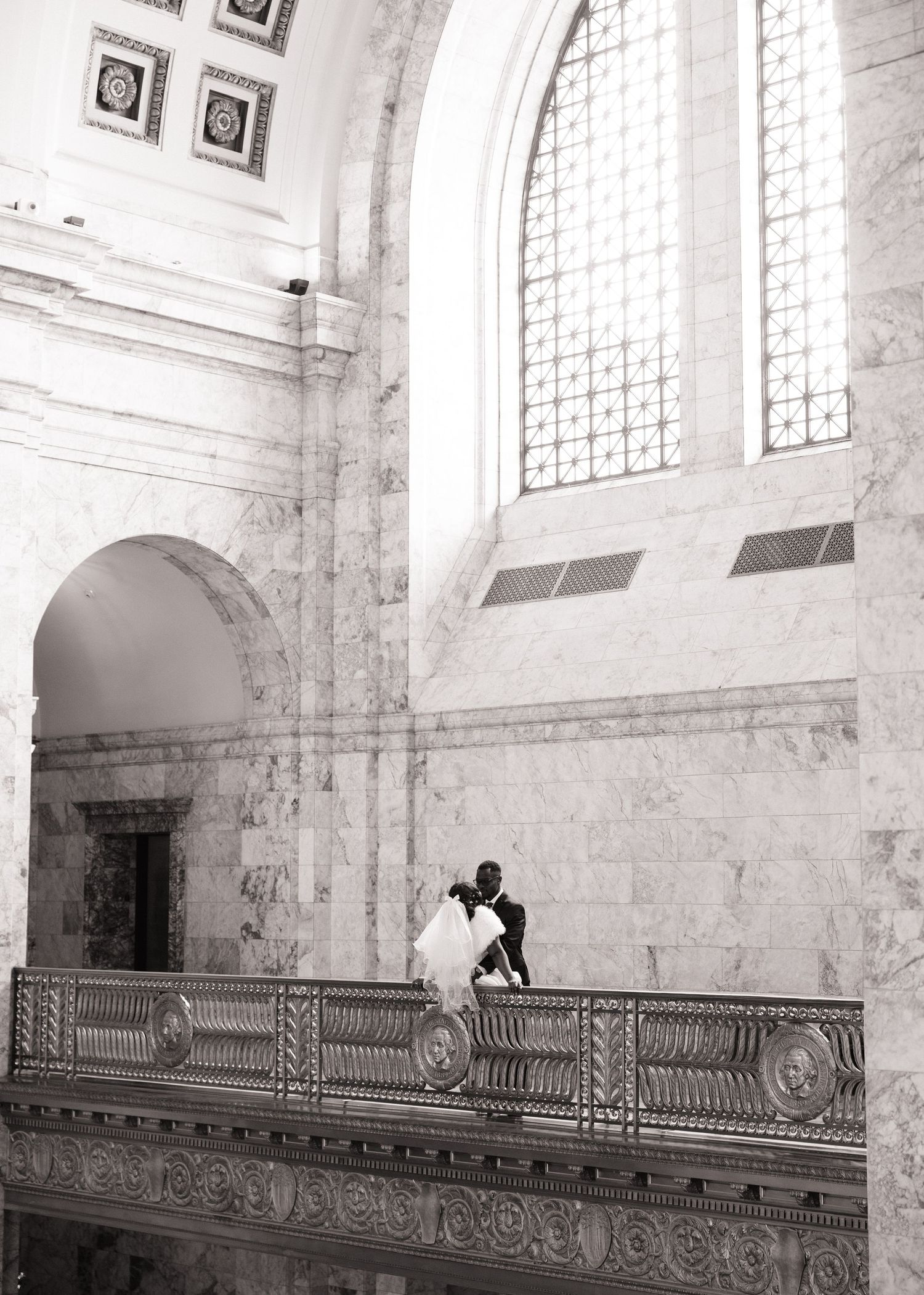 Bride and groom framed by the grand interior of the Washington State Capitol during their Olympia wedding