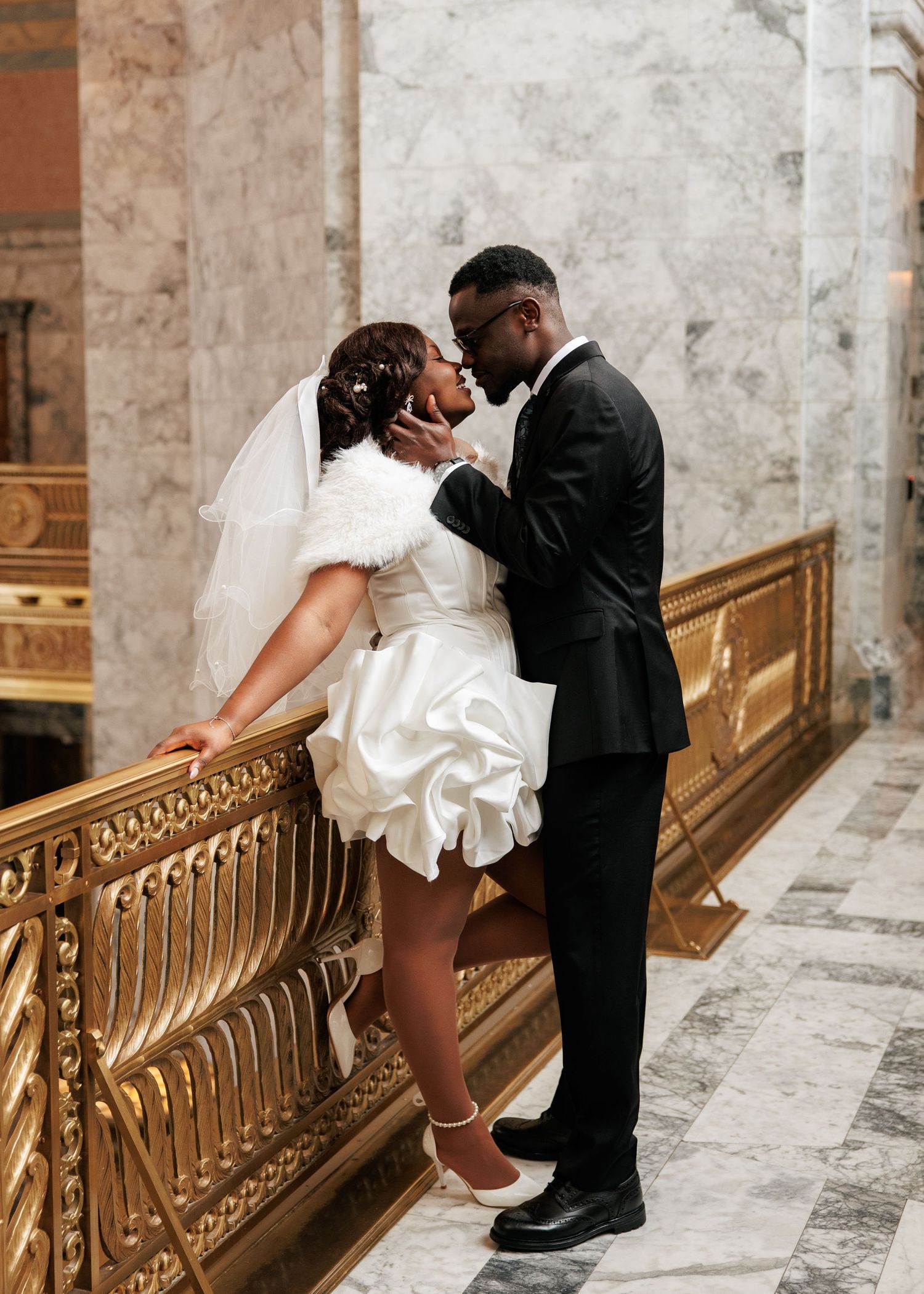 Newlyweds sharing an intimate moment inside the Washington State Capitol during their Olympia wedding portraits.