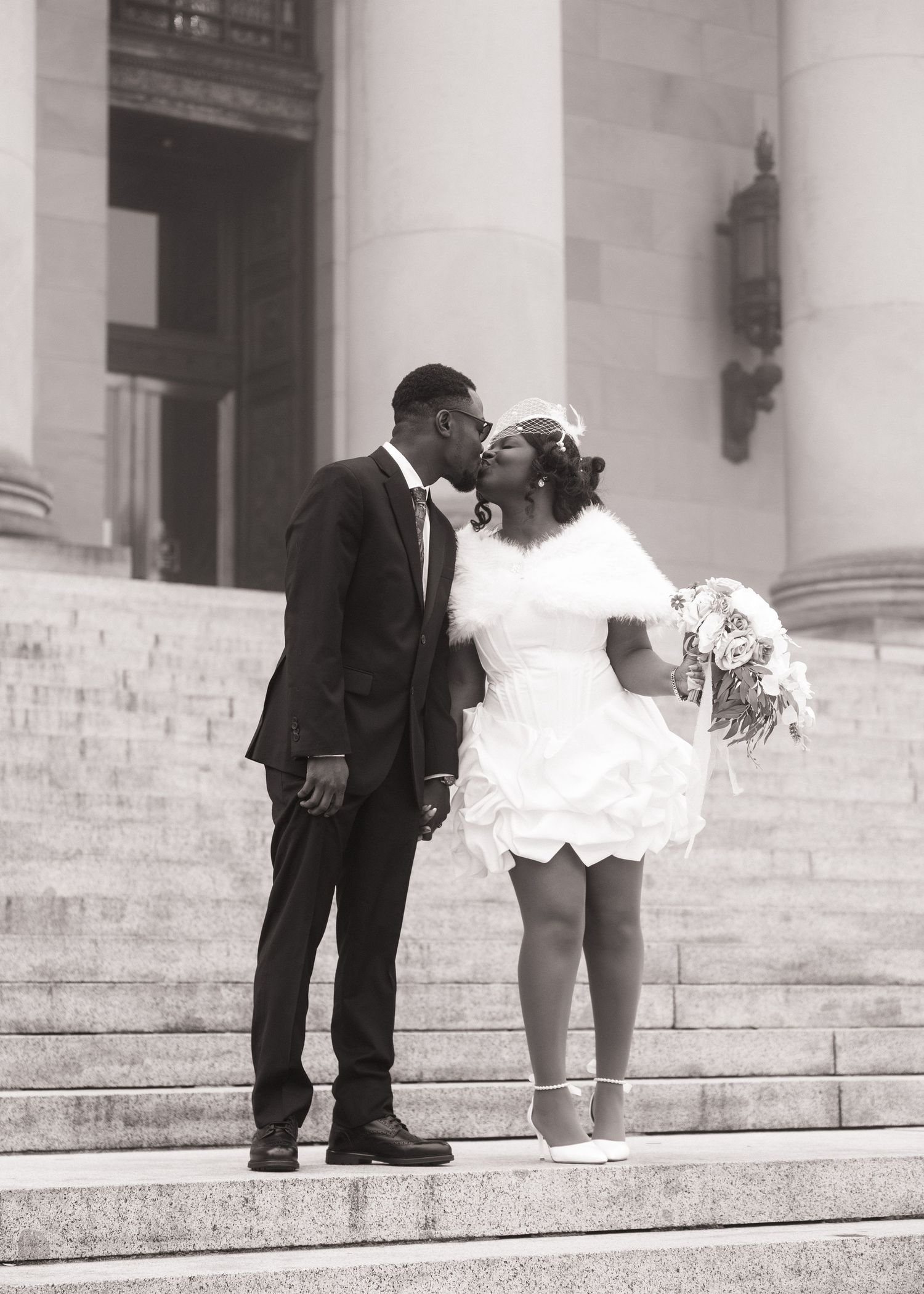 Newlyweds sharing a kiss on the Washington State Capitol steps in Olympia