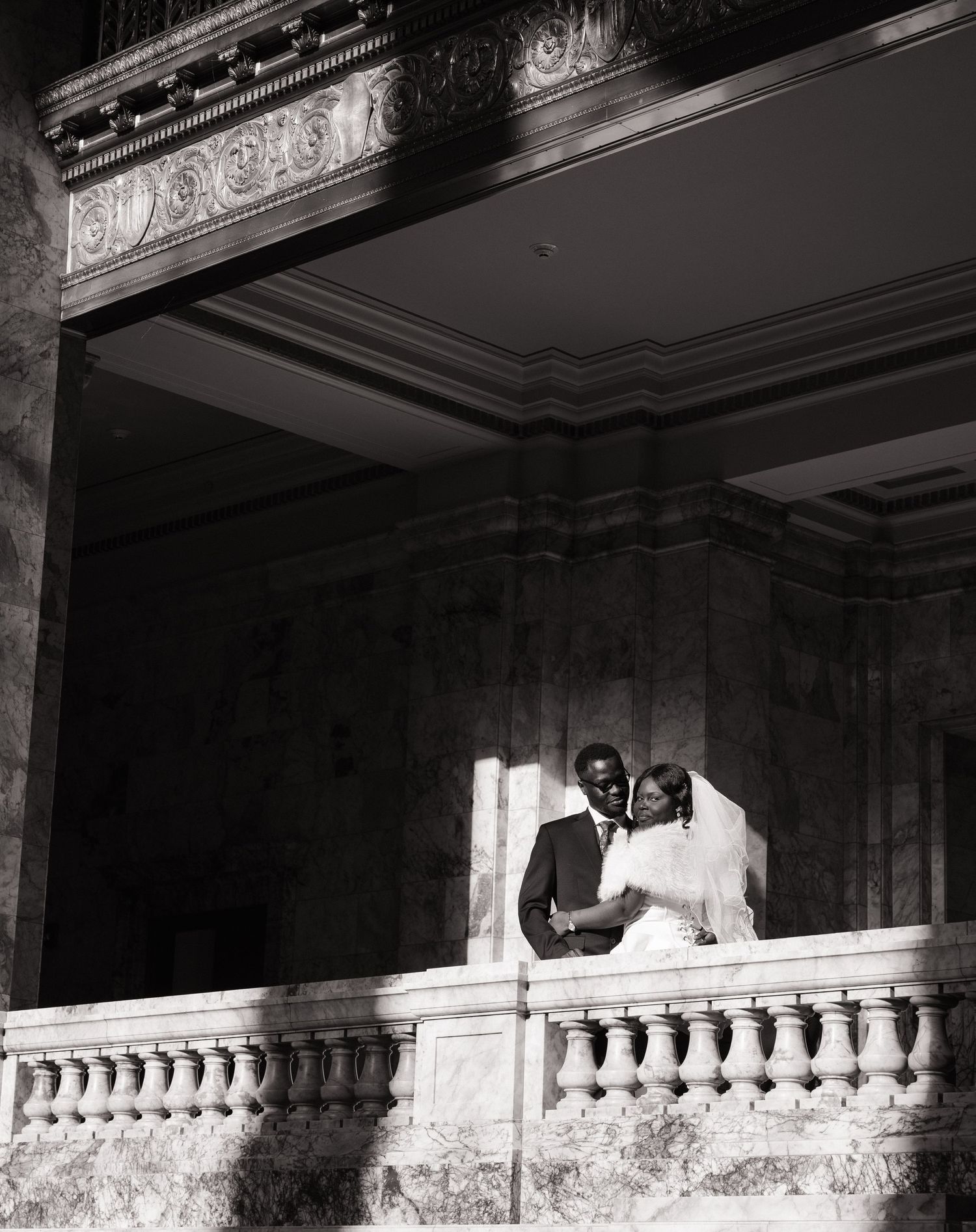 Bride and groom framed by the architecture inside the Washington State Capitol in Olympia