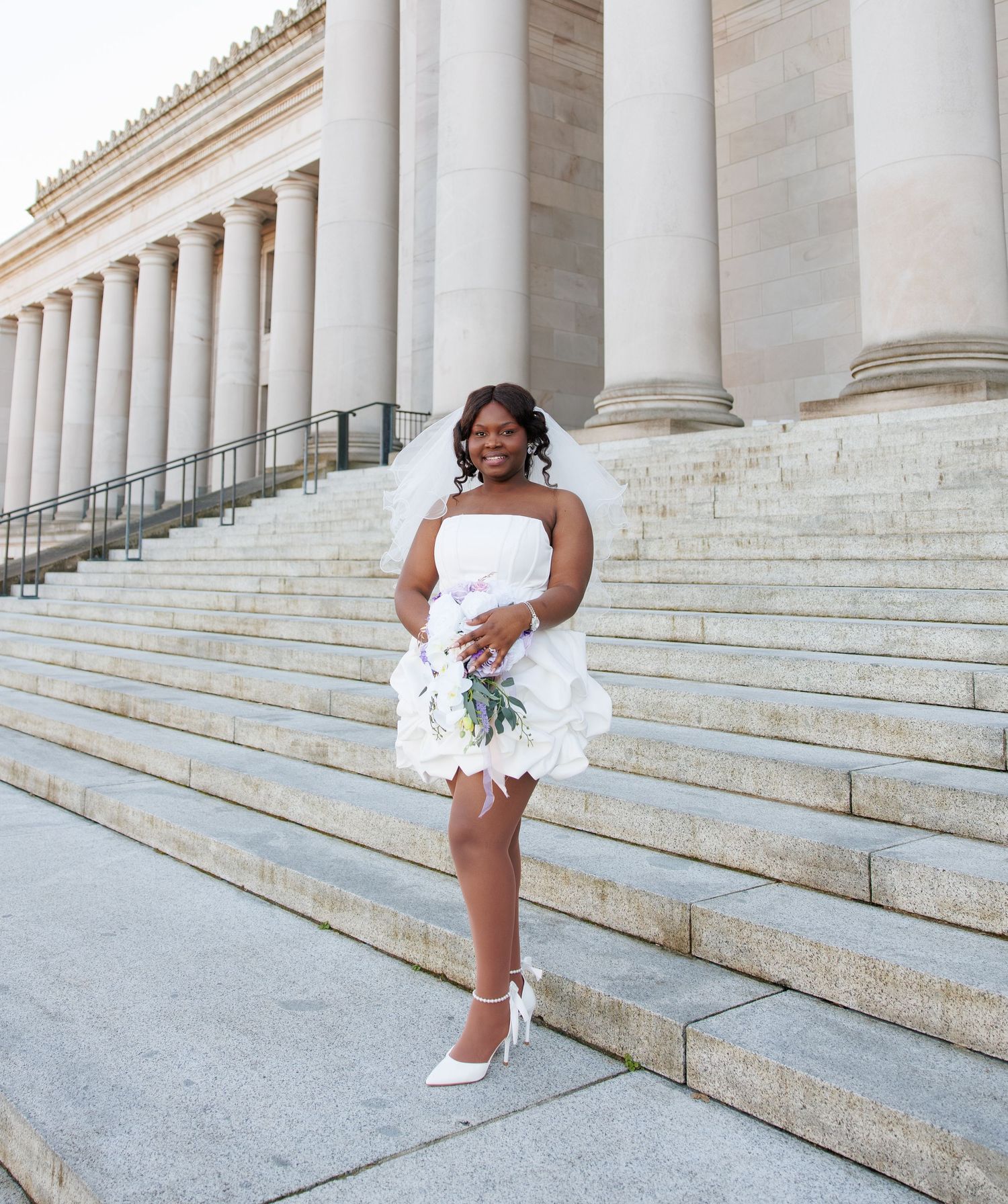 Bride posing with her bouquet on the Washington State Capitol steps in Olympia
